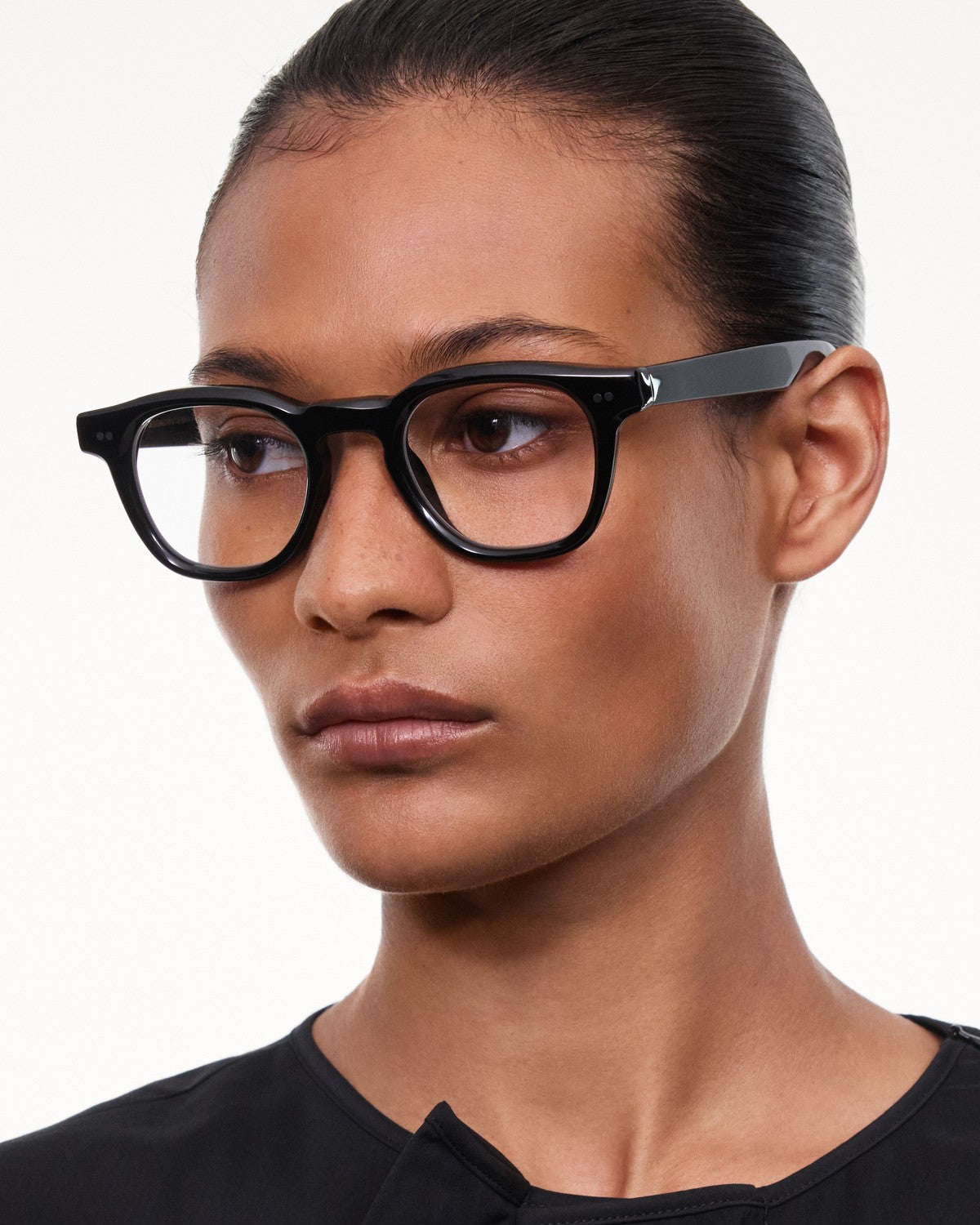 Angled view of model wearing CHIMI 01 Core Black Clear eyeglasses with hair pulled back.