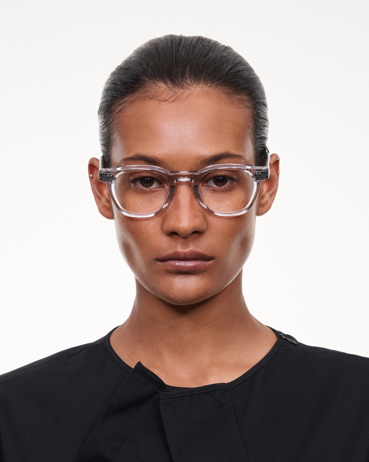 Model wearing CHIMI 01 Core Grey Clear eyeglasses with a direct gaze.