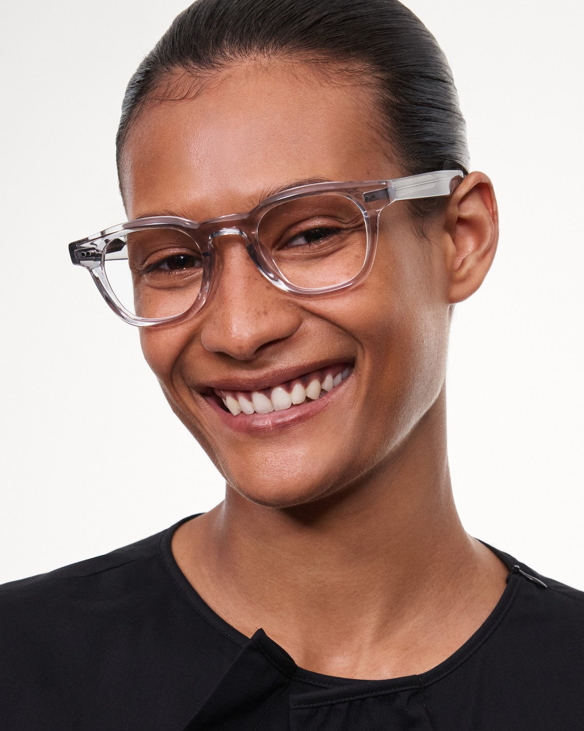 Model smiling while wearing CHIMI 01 Core Grey Clear eyeglasses.