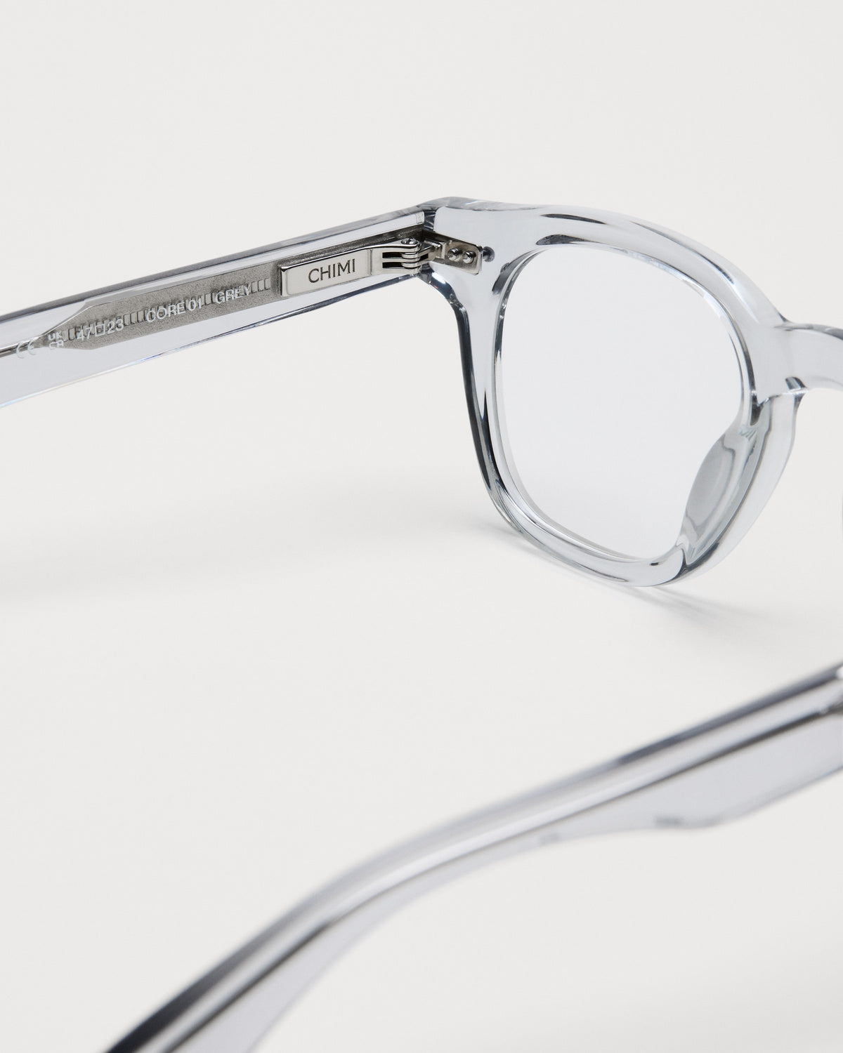 Close-up of the frame and hinge details on CHIMI 01 Core Grey Clear Eyeglasses