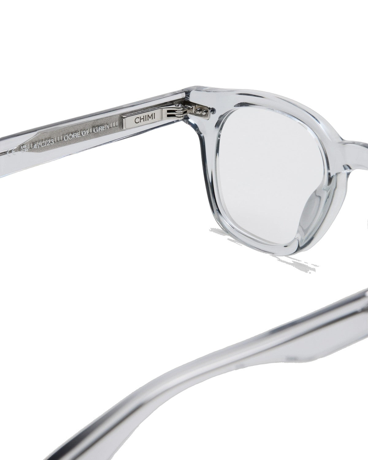 Detail of the temple hinge and branding on CHIMI 01 Core Grey Clear eyeglasses.