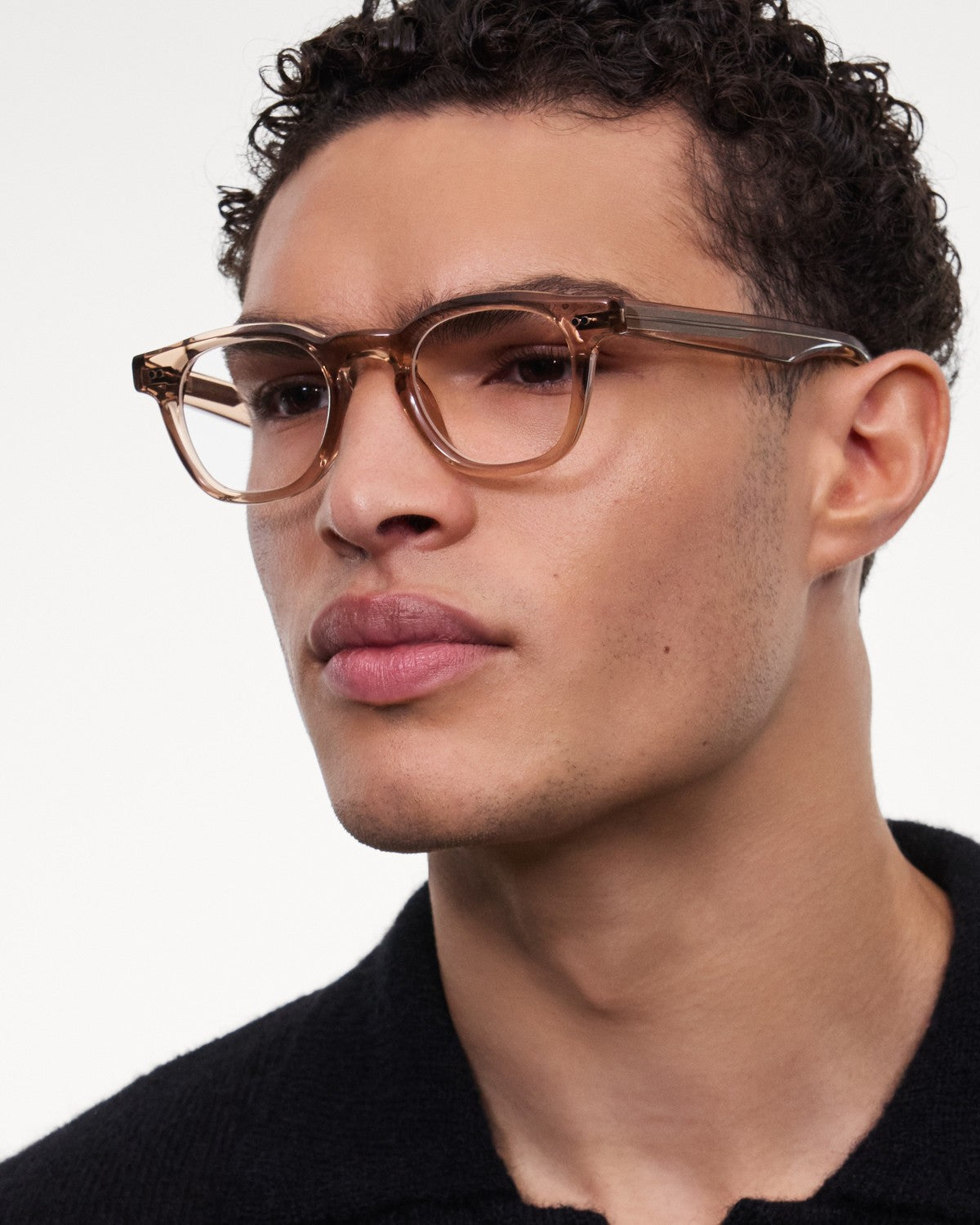 Model wearing CHIMI 01 Core Light Brown Clear eyeglasses, angled view.