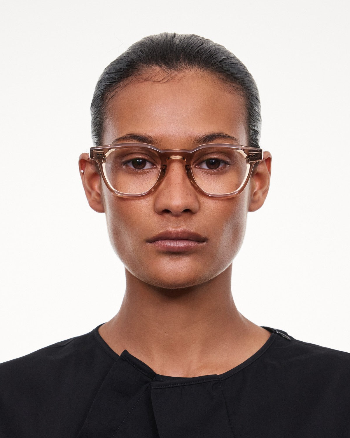Model wearing CHIMI 01 Core Light Brown Clear eyeglasses, front view.