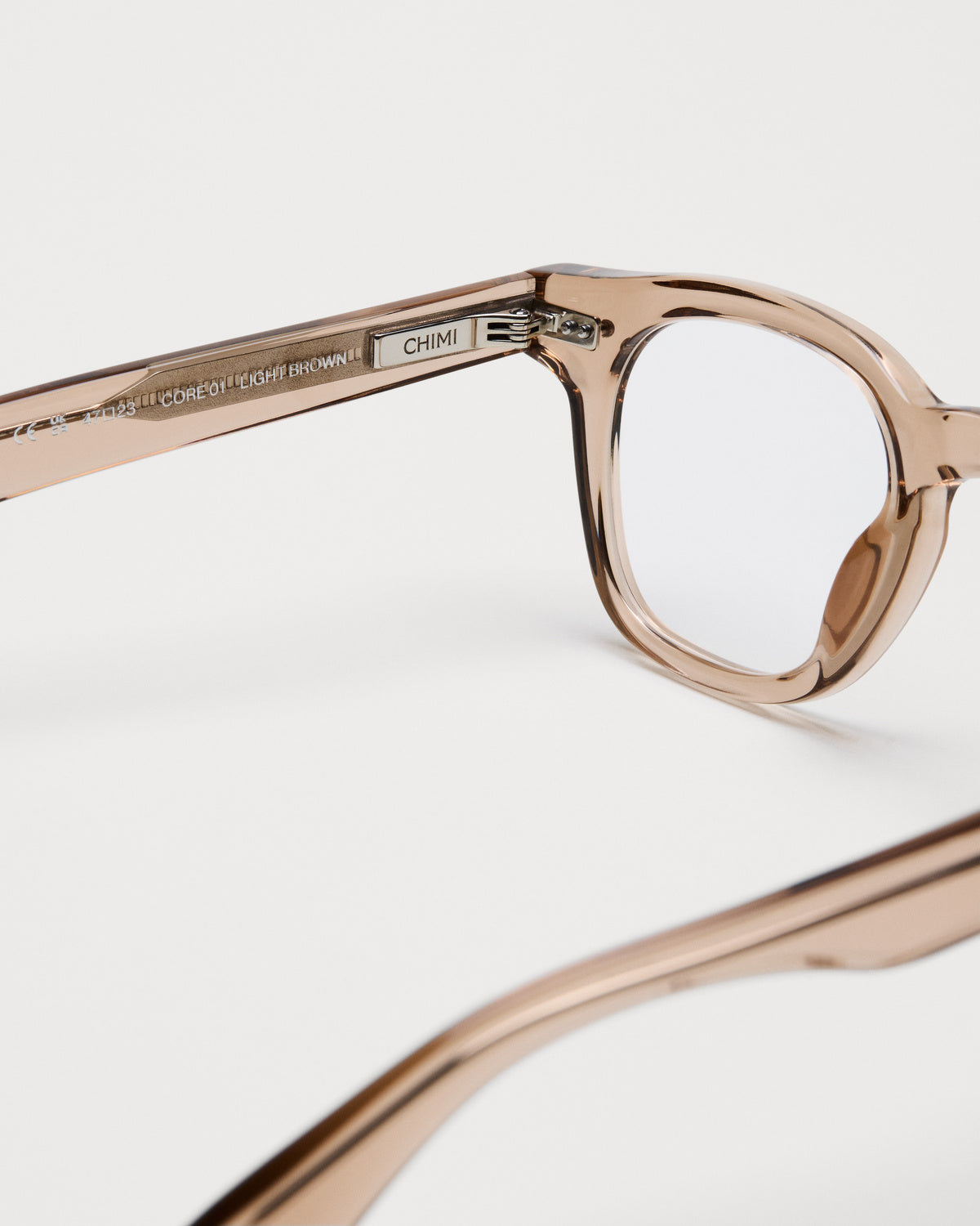 Close-up of the frame and hinge details on CHIMI 01 Core Light Brown Clear Eyeglasses