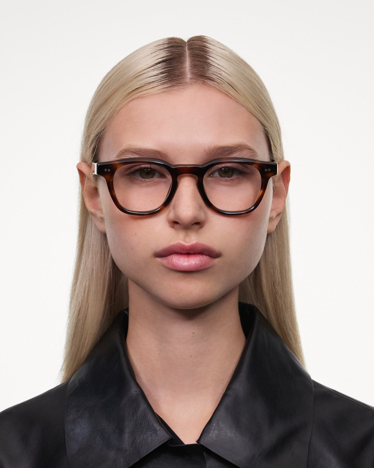 Model wearing CHIMI 01 Core Tortoise Clear eyeglasses with black collared shirt.