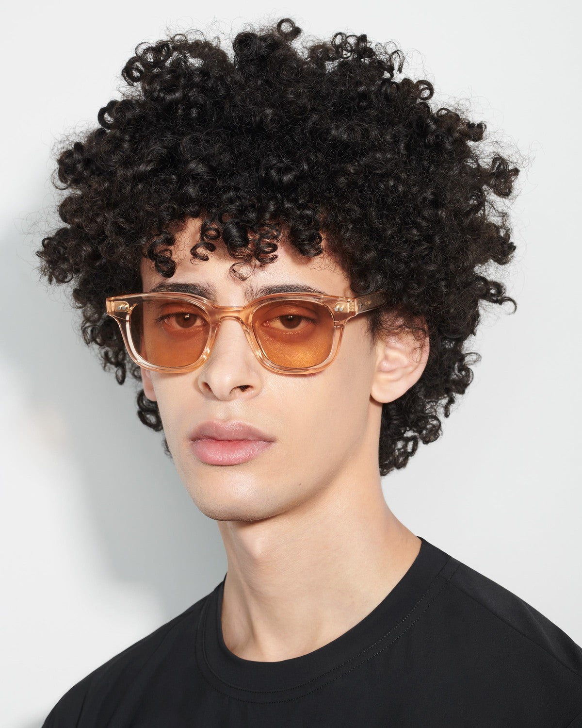 Side profile of model wearing CHIMI 02 Light Orange sunglasses.