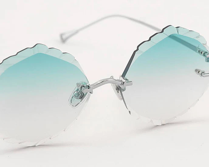 Close-up of the scalloped rimless lens edge and bridge on EYEPETIZER Guadalupe C.1-59 sunglasses.