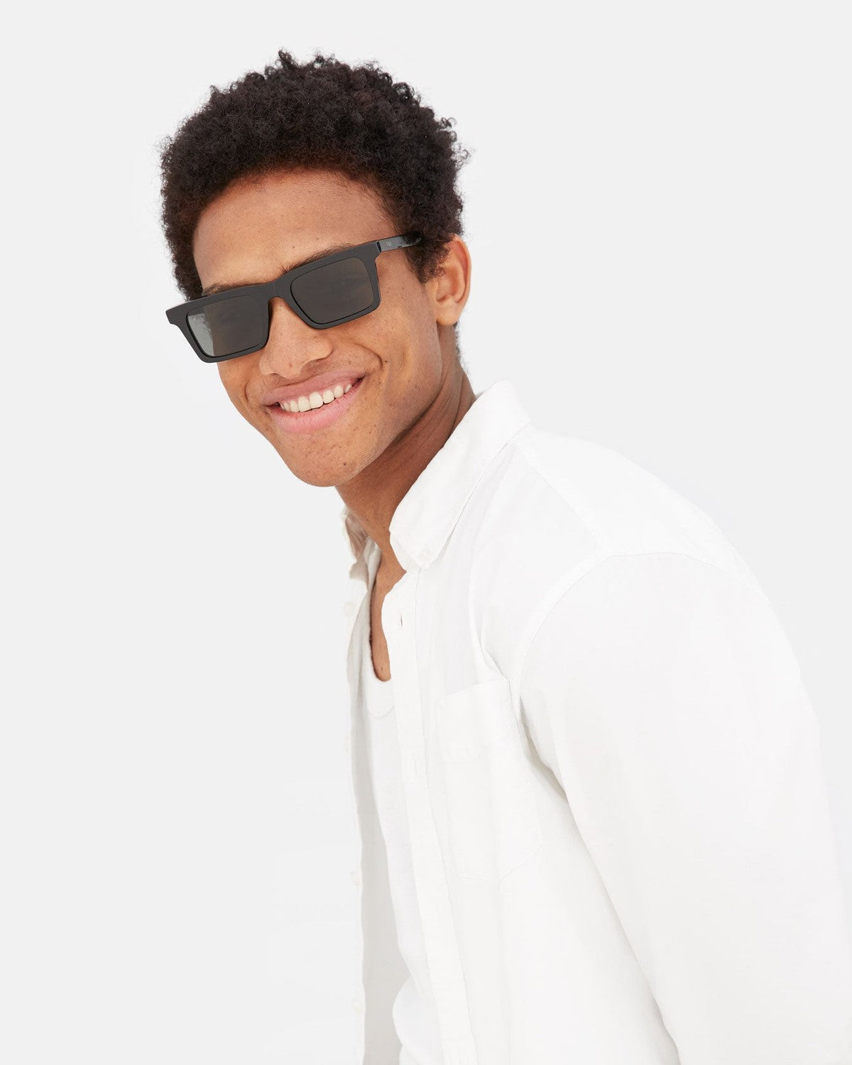 Model wearing RETROSUPERFUTURE 1968 Black sunglasses indoors.