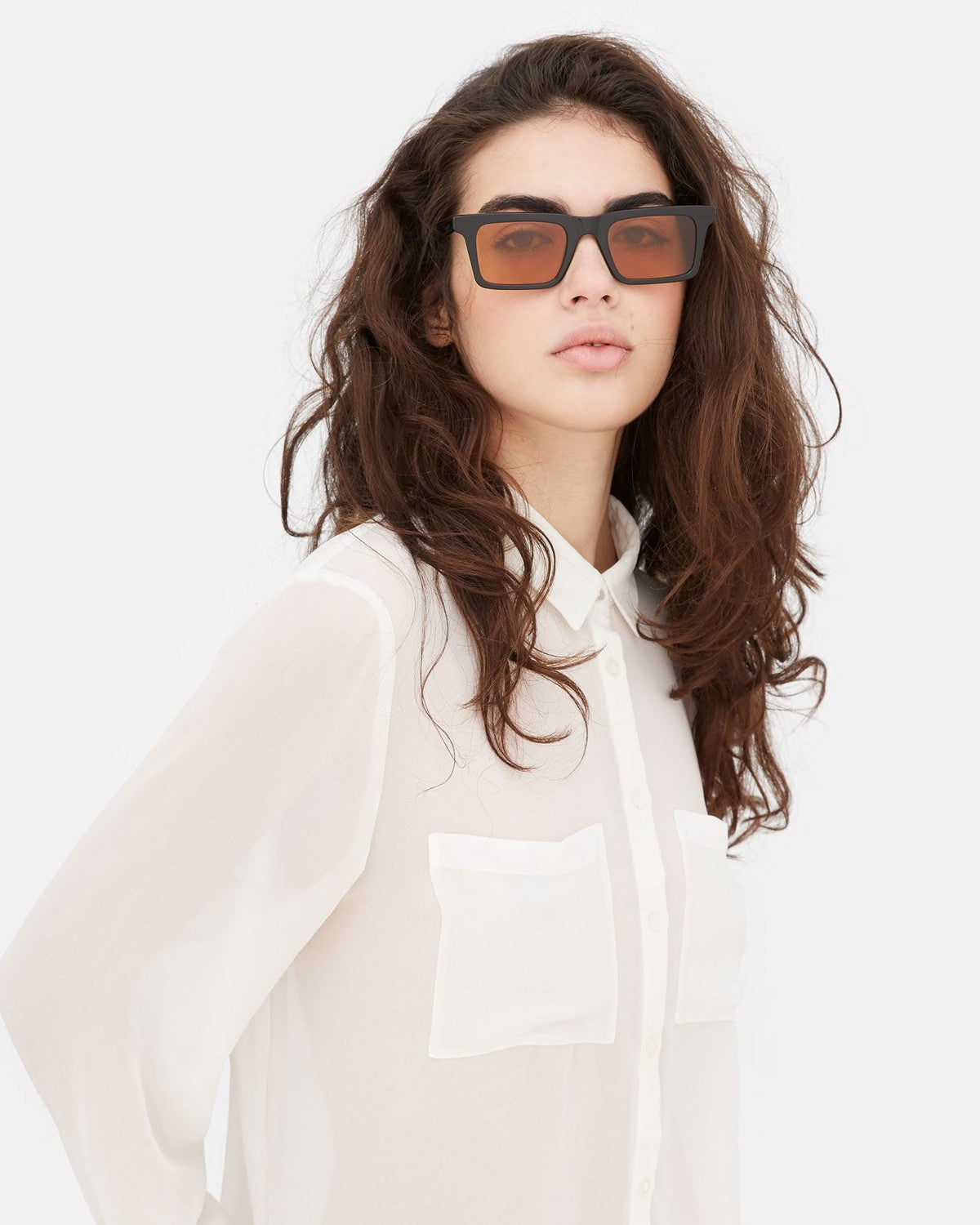 Model wearing RETROSUPERFUTURE 1968 Refined sunglasses with white shirt.