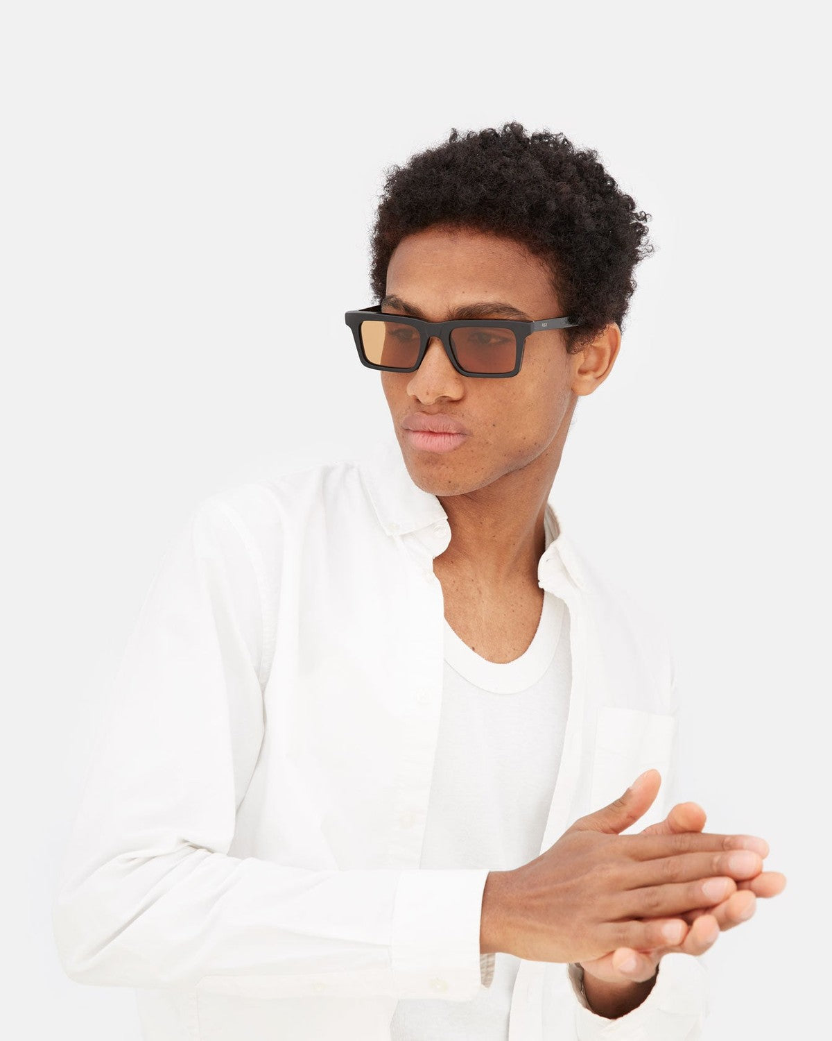 Model wearing RETROSUPERFUTURE 1968 Refined sunglasses in white shirt.