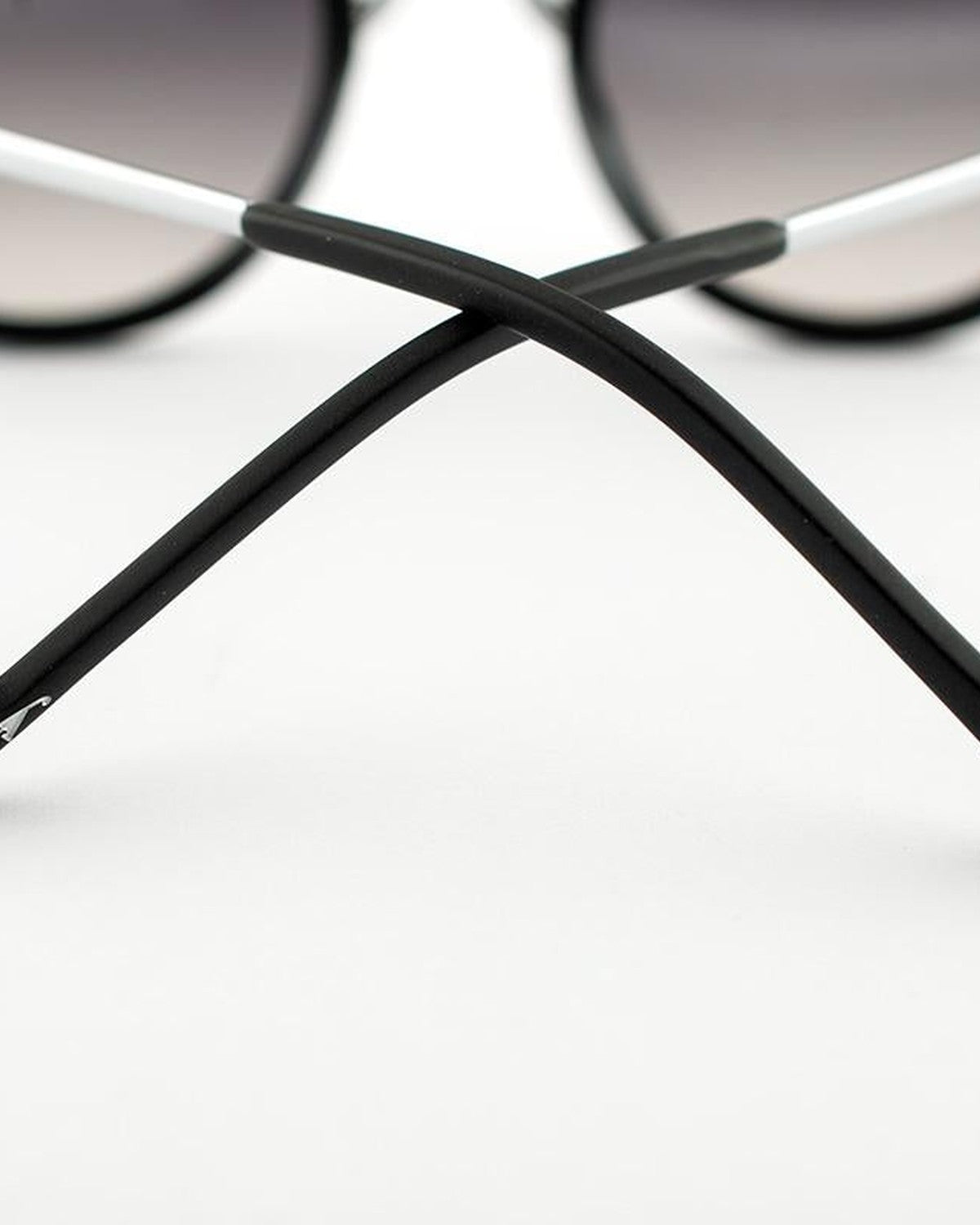 Close-up of crossed temples showing matte texture on EYEPETIZER 55 C.A-1-27F sunglasses.