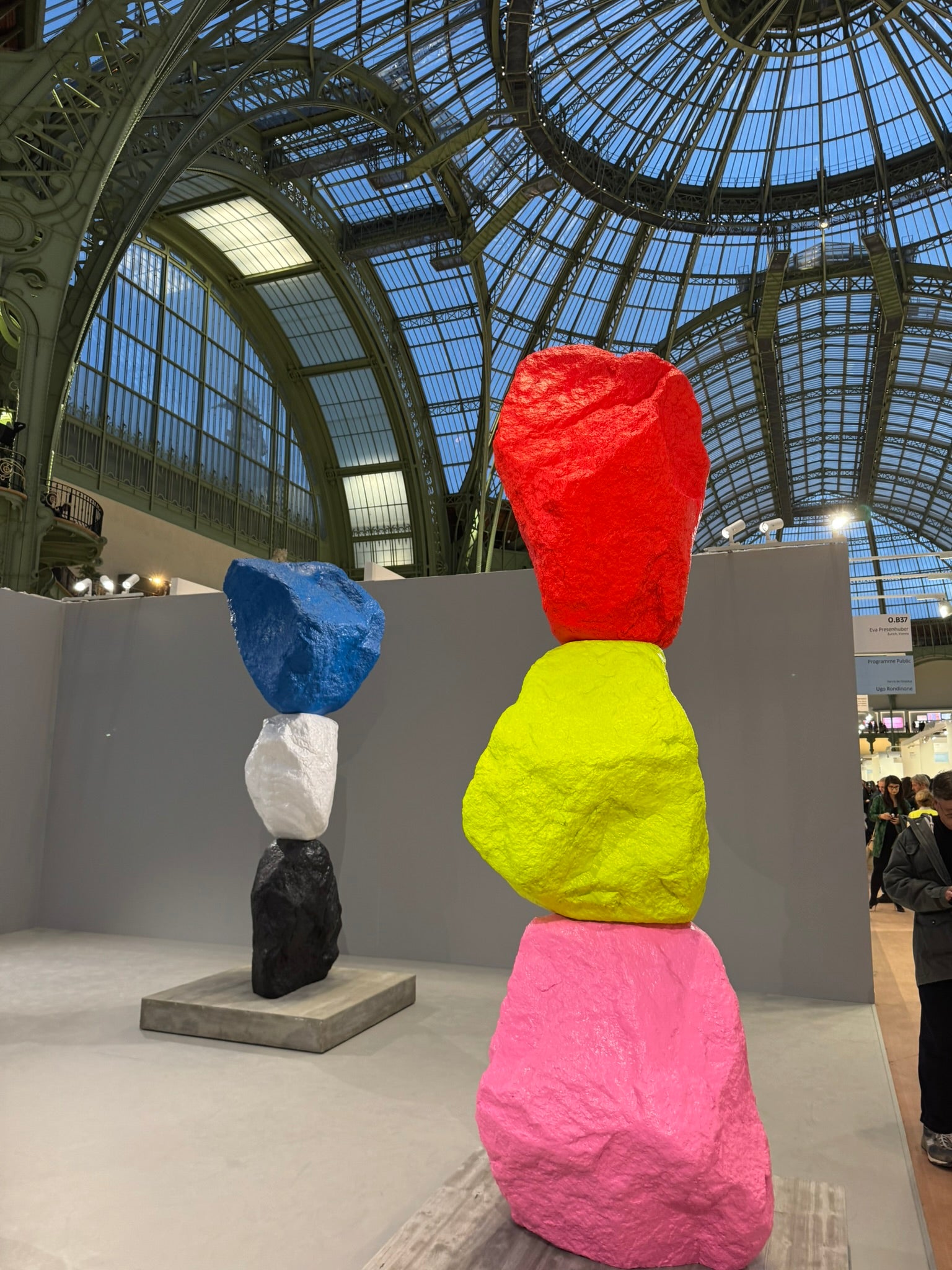 Colorful sculpture in a gallery setting with a large glass ceiling