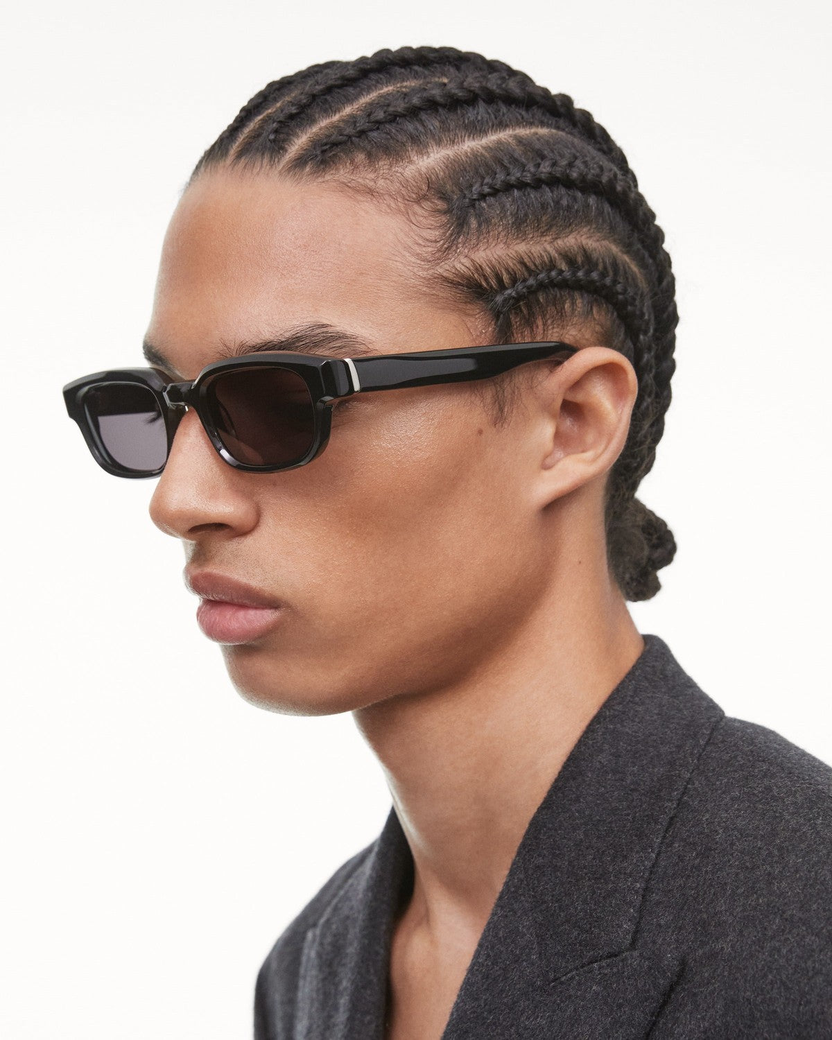 Side profile of model wearing CHIMI Alter Black sunglasses.