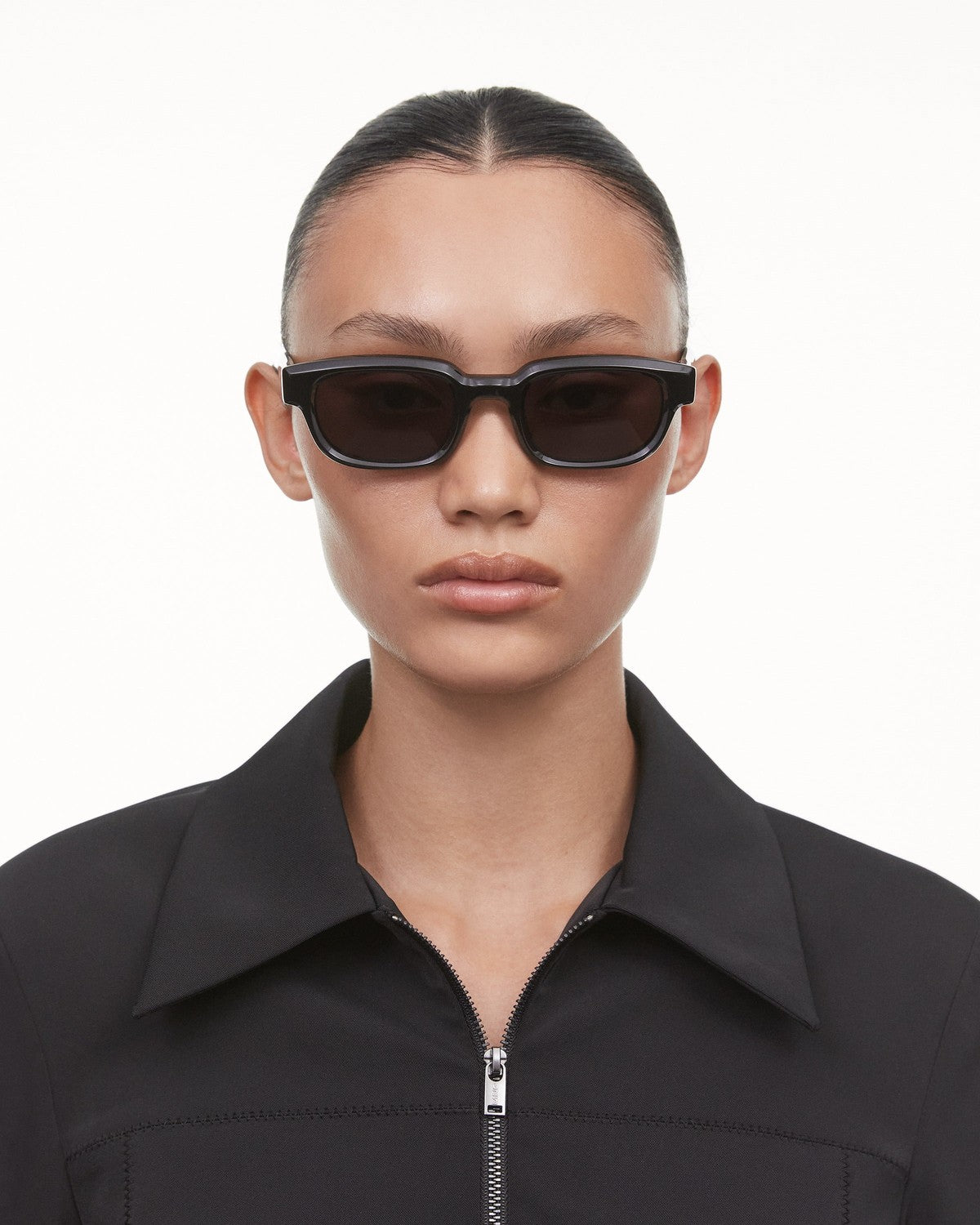 Model wearing CHIMI Alter Black sunglasses, frontal portrait.
