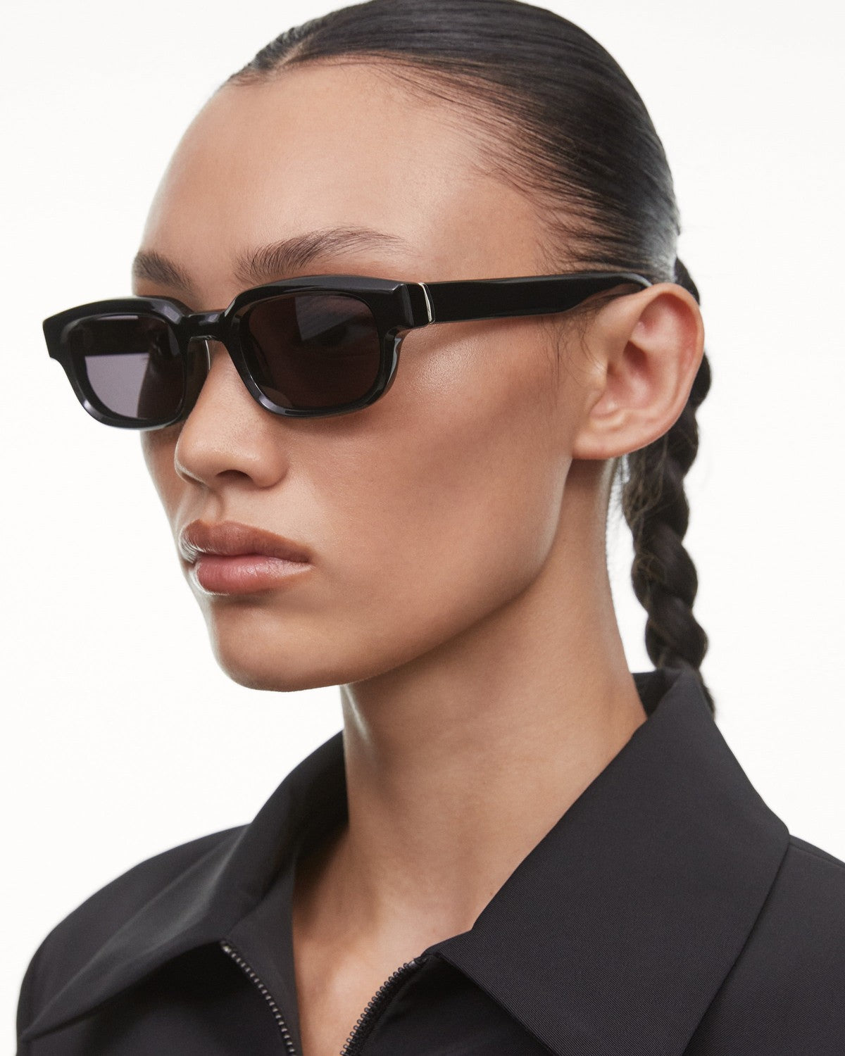 Side angle of model wearing CHIMI Alter Black sunglasses showing left temple.