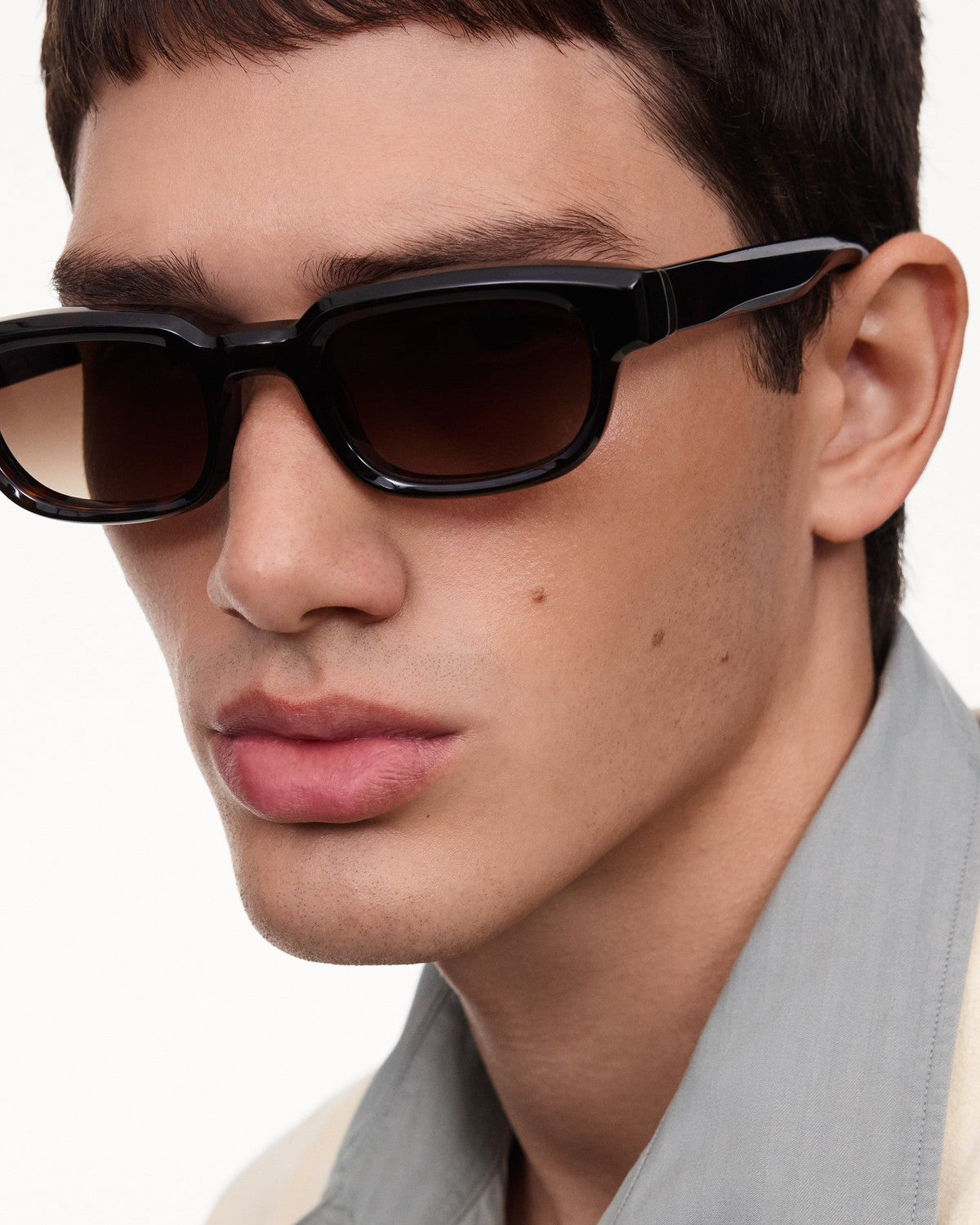 Model wearing CHIMI Alter Tortoise Brown sunglasses, angled view.