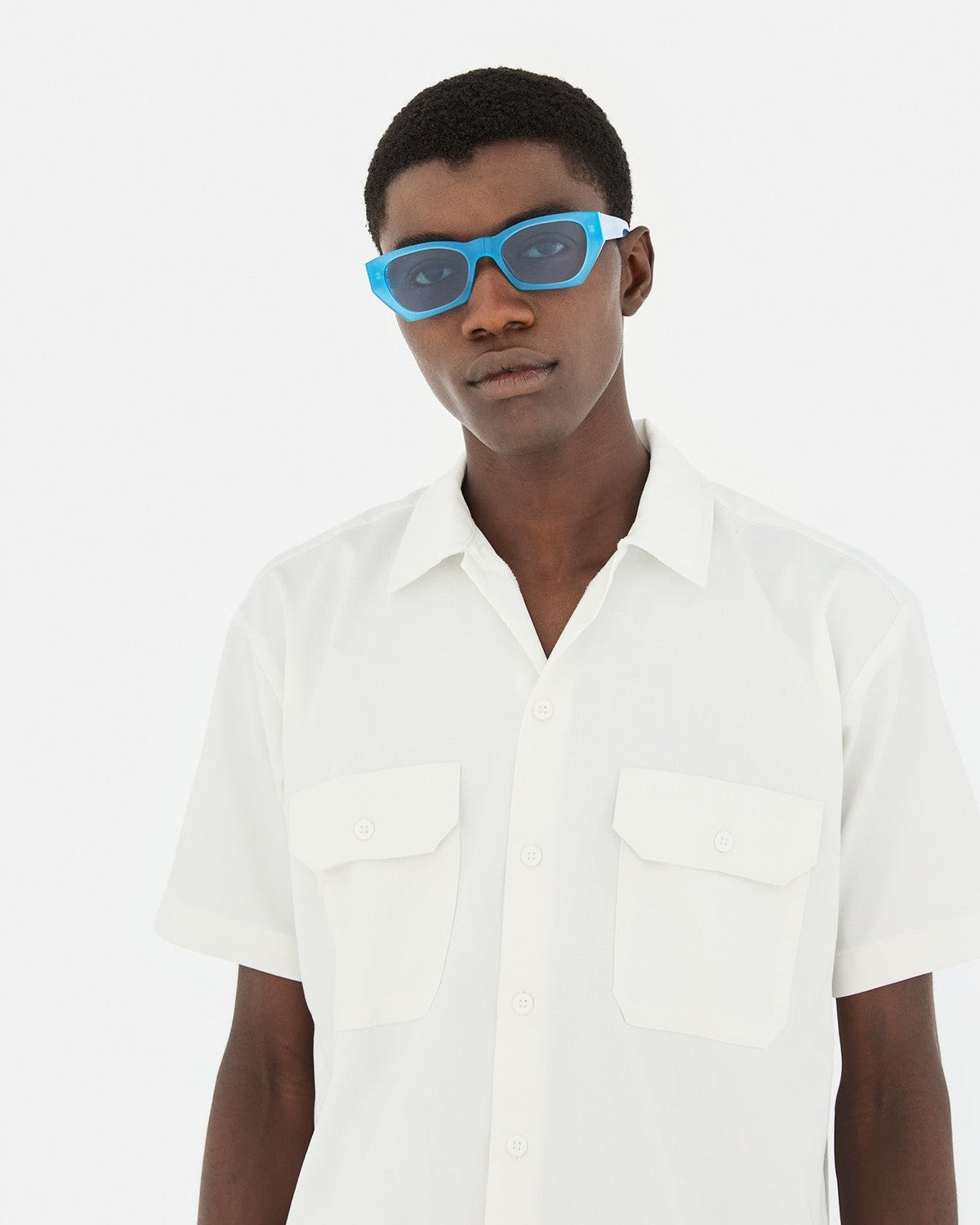 Model wearing RETROSUPERFUTURE Amata Estate Anice sunglasses with white shirt.