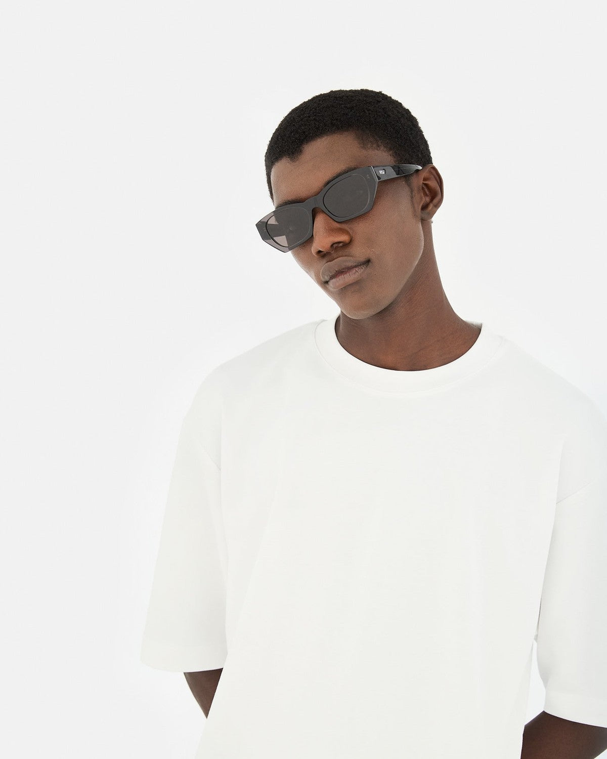 Model wearing RETROSUPERFUTURE Amata Estate Liquirizia sunglasses, angled pose.