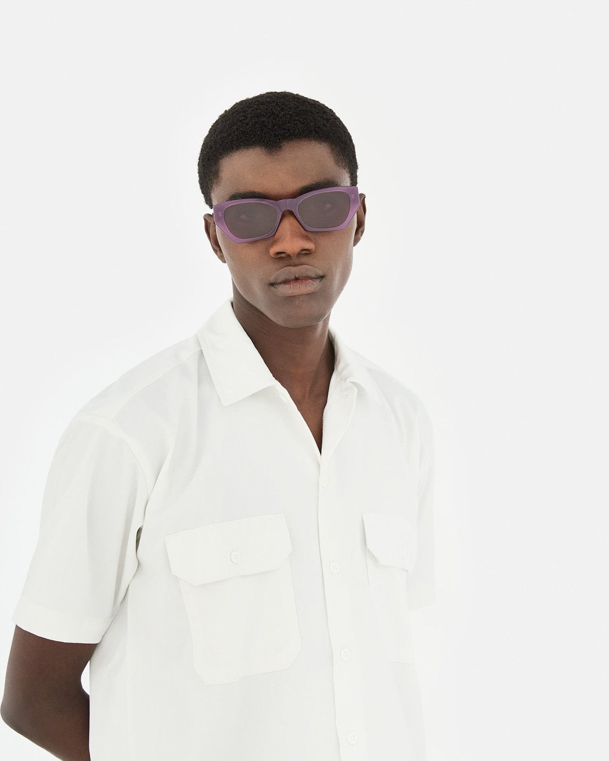 Model wearing RETROSUPERFUTURE Amata Estate Mirtillo sunglasses with white shirt.