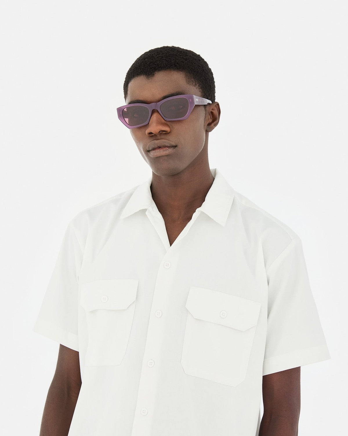 Model in white shirt wearing RETROSUPERFUTURE Amata Estate Mirtillo sunglasses.