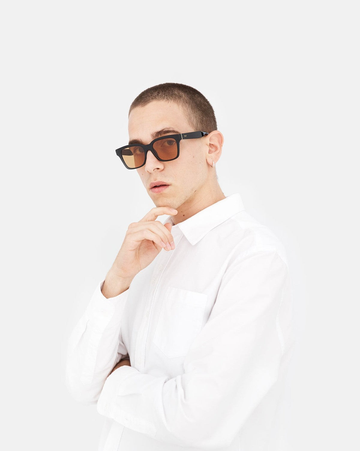 Model wearing RETROSUPERFUTURE America Refined sunglasses with white shirt.