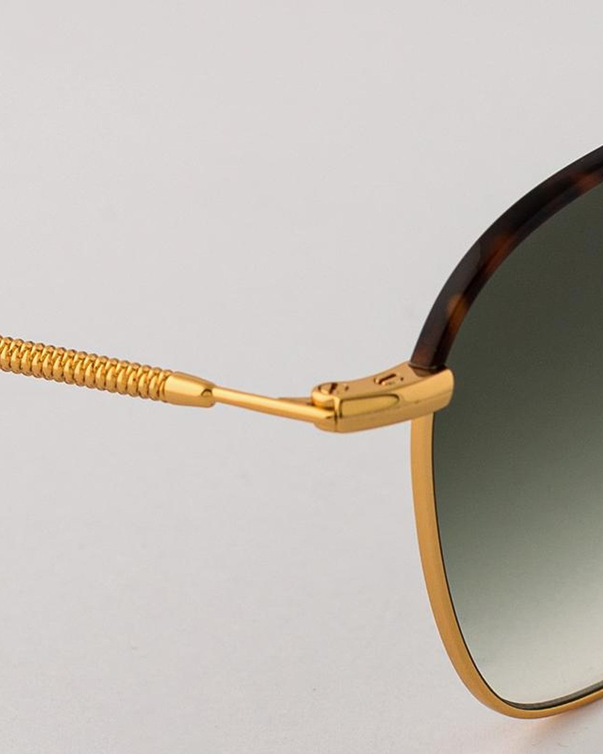 Detail of the coiled temple and hinge on EYEPETIZER ATACAMA C.4-M-25 sunglasses.