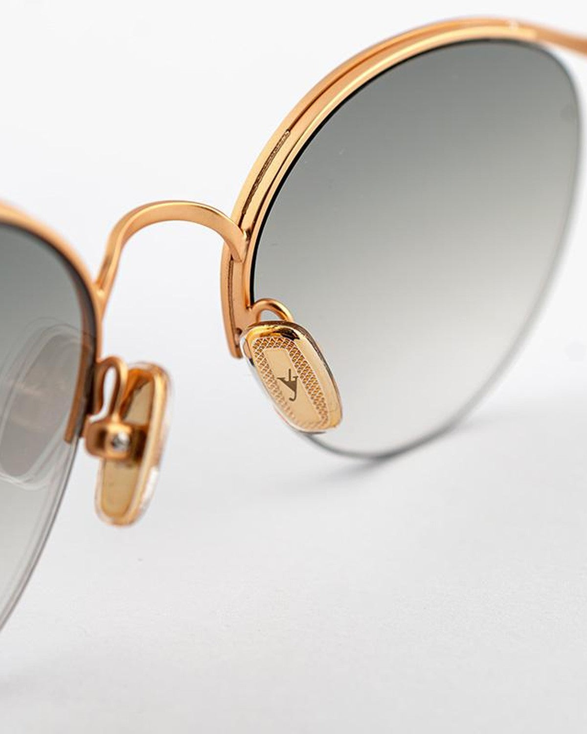 Close-up of the bridge and temple hinge with engraved logo on EYEPETIZER AUGUSTO C.4-OP-25F sunglasses.
