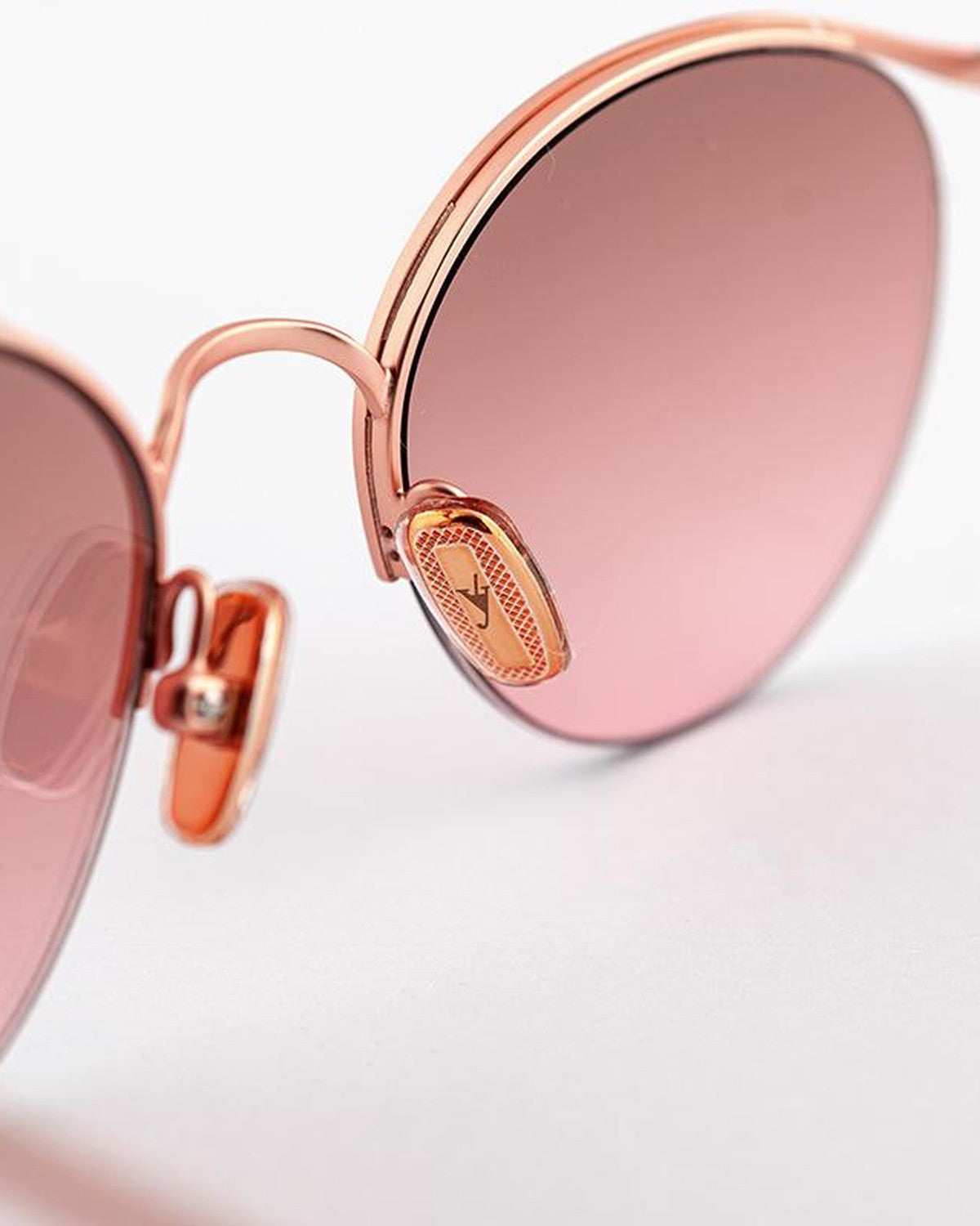 Close-up of the nose bridge and branded logo medallion on EYEPETIZER AUGUSTO C.9-OP-44F sunglasses.