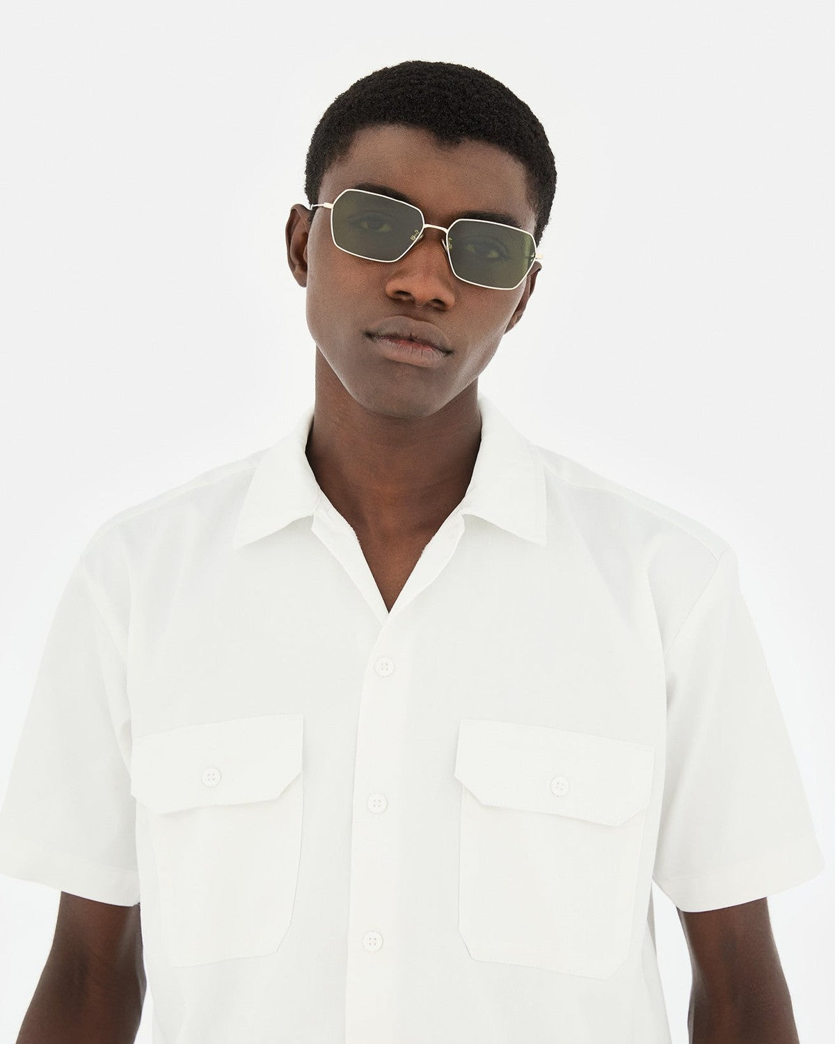 Model wearing RETROSUPERFUTURE Balarm Classico sunglasses with white shirt.
