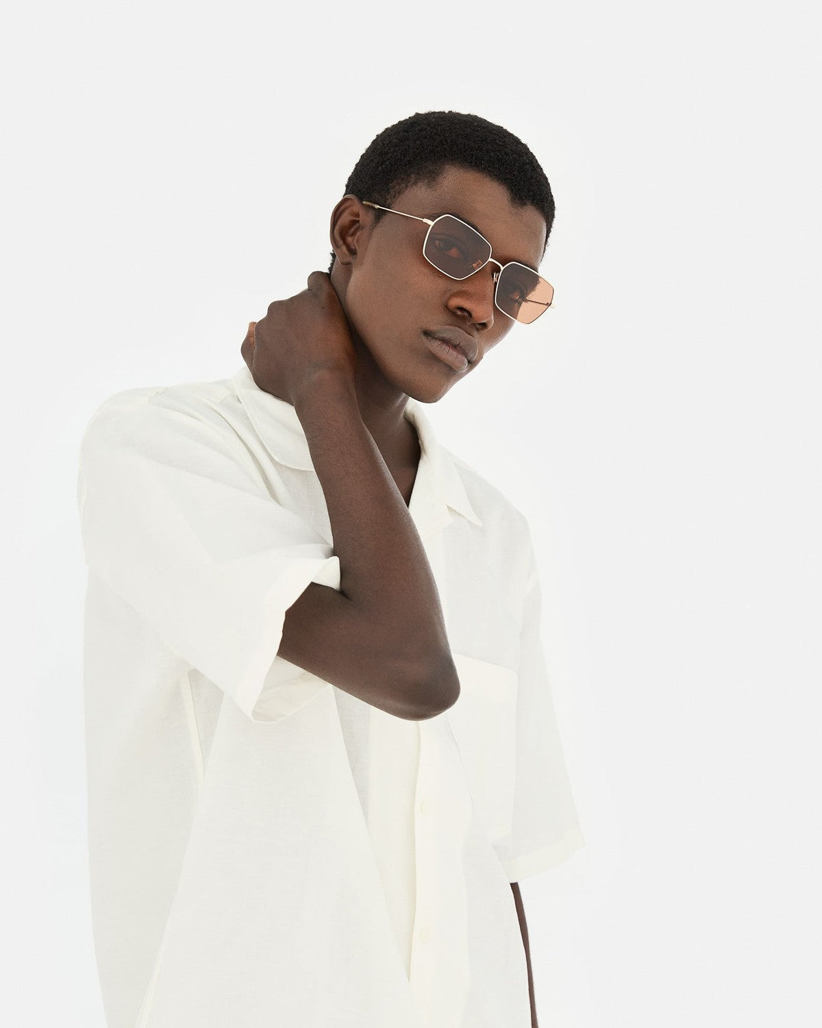 Model in white jacket wearing RETROSUPERFUTURE Balarm Graffiato sunglasses.