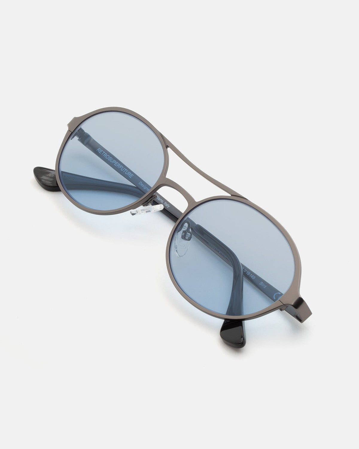 Overhead view of RETROSUPERFUTURE Bird Blue-Gun sunglasses with folded temples.