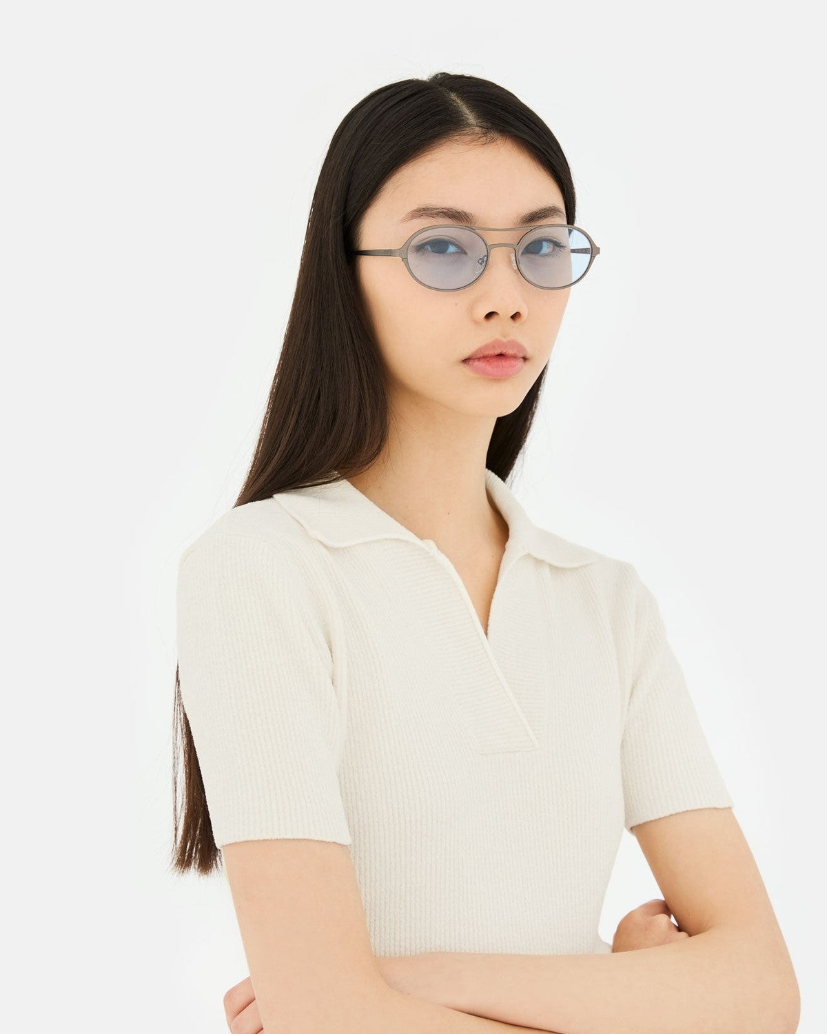 Model wearing RETROSUPERFUTURE Bird Blue-Gun sunglasses with a white collared shirt.