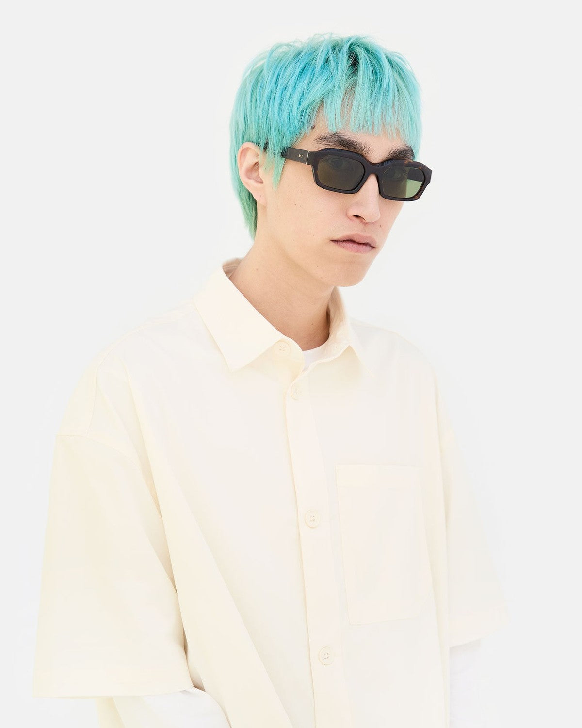 Side profile of model wearing RETROSUPERFUTURE Boletus 3627 sunglasses with turquoise hair.