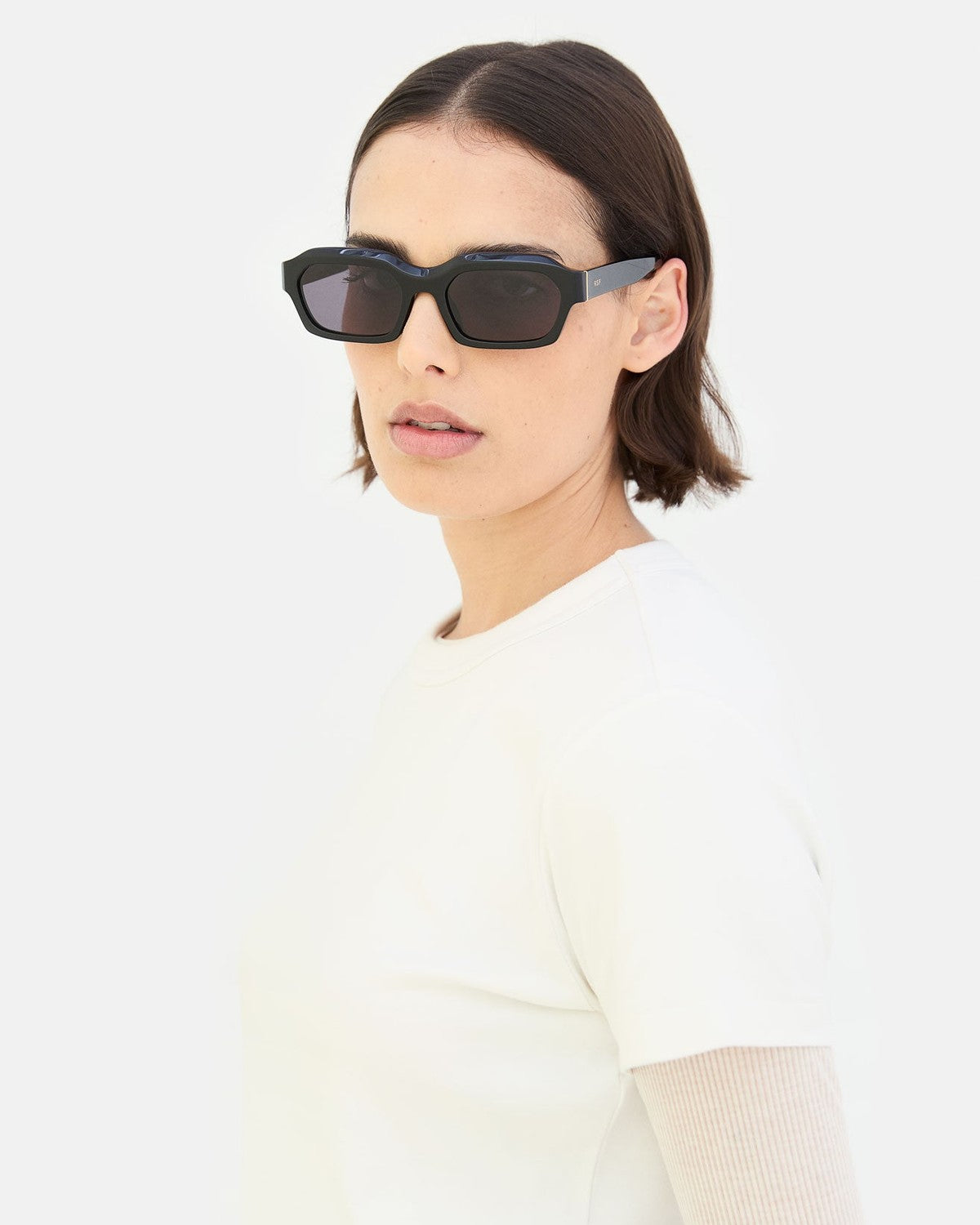 Model wearing RETROSUPERFUTURE Boletus Black sunglasses, three-quarter view.