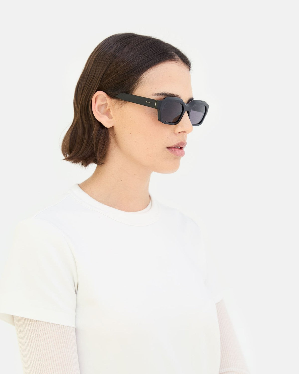Side profile of model wearing RETROSUPERFUTURE Boletus Black sunglasses.