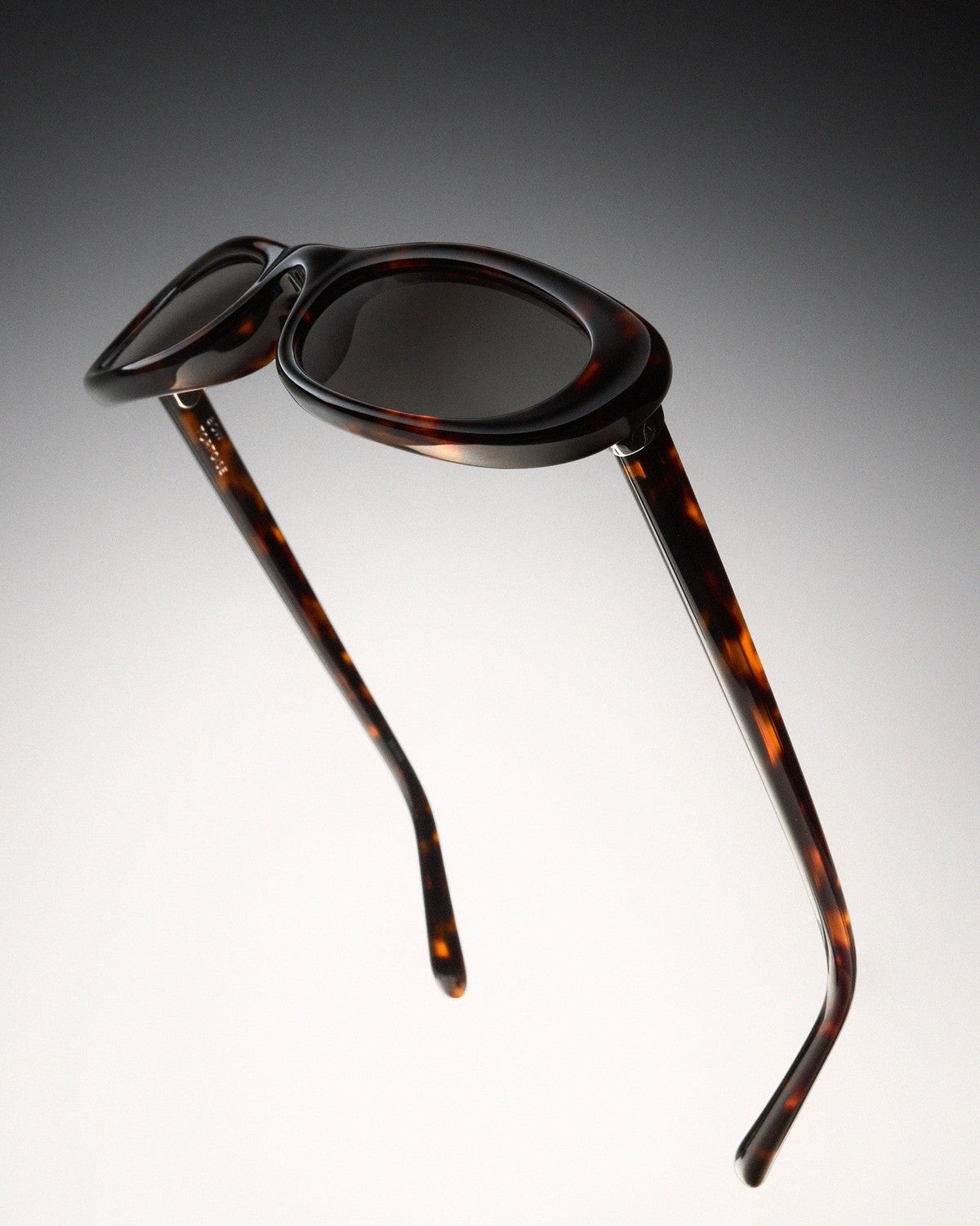 Folded view showing the tortoise temples of CHIMI Bow Tortoise Green sunglasses.