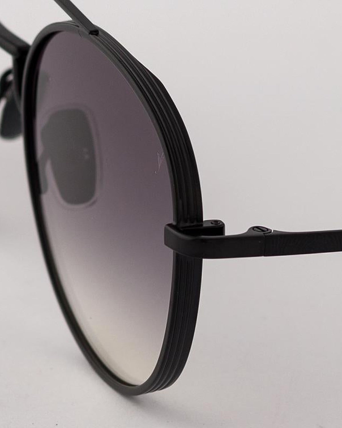 Close-up of the ridged temple and hinge detail on EYEPETIZER BUILD C.6-27 sunglasses.