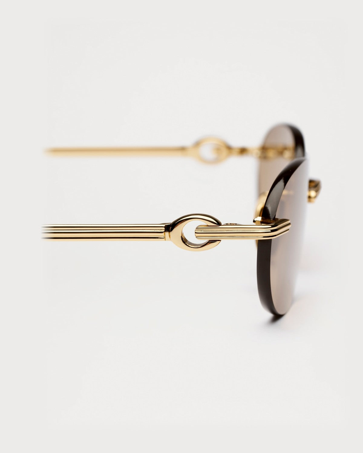 Close-up of the decorative temple detail on CHIMI Cadenza Oval Brown sunglasses.