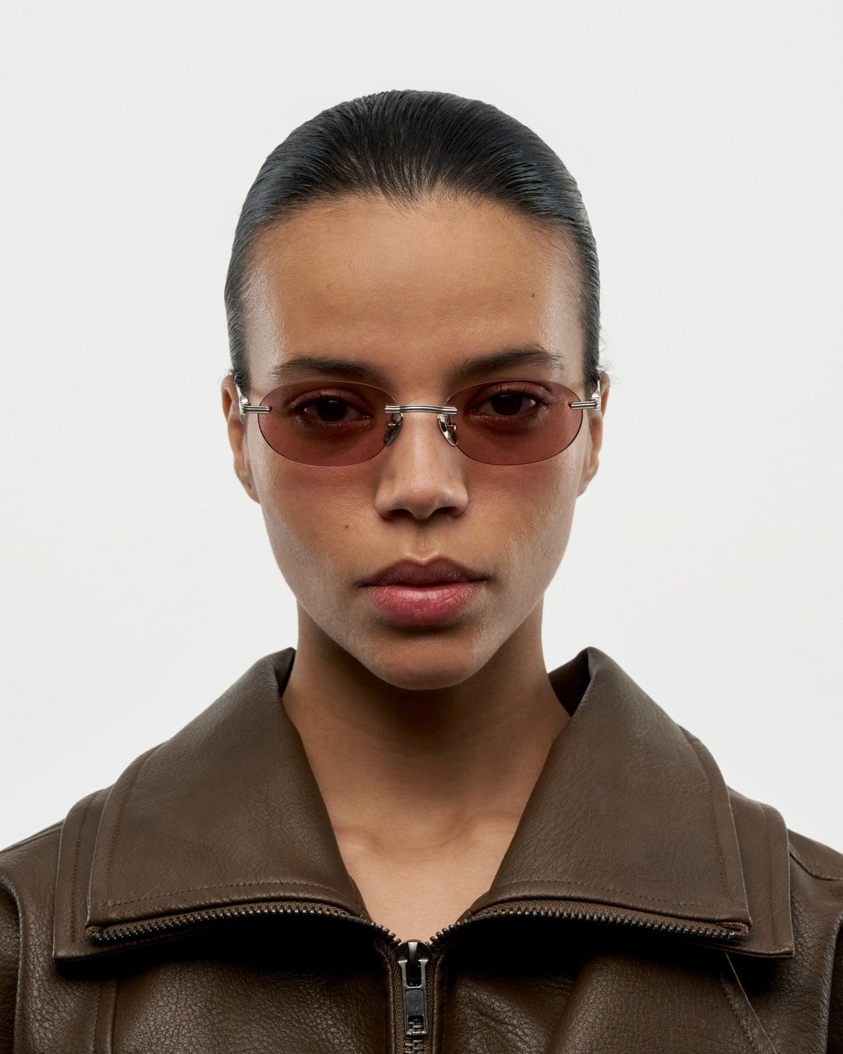 Model wearing CHIMI Cadenza Oval Pink Low sunglasses, front view.