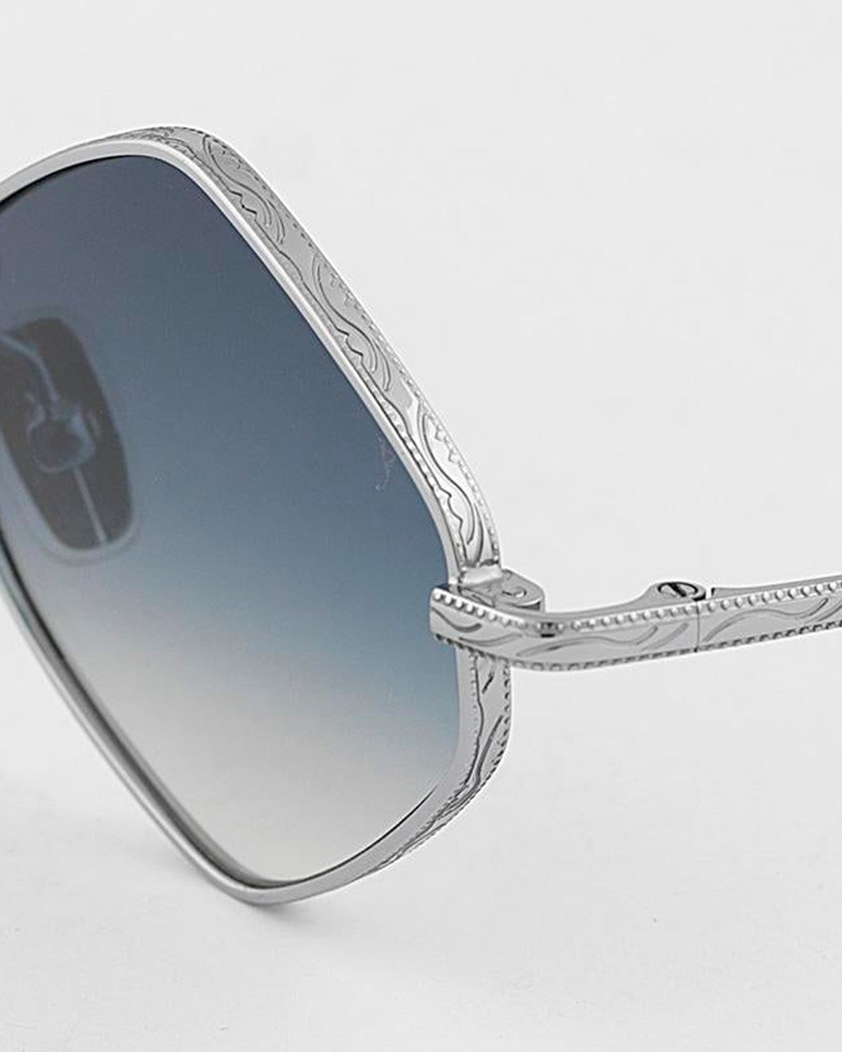 Close-up of the engraved metal rim on EYEPETIZER CANAR C.1-26 sunglasses.