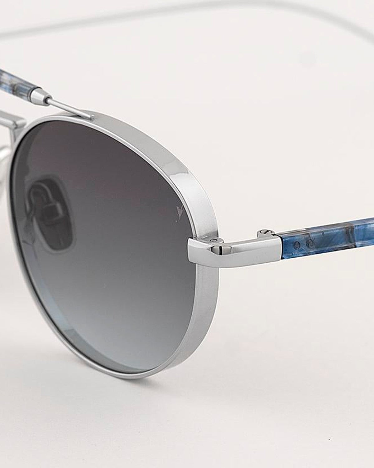 Close-up of the left lens and temple junction on EYEPETIZER CARIBE C.1-69 sunglasses.