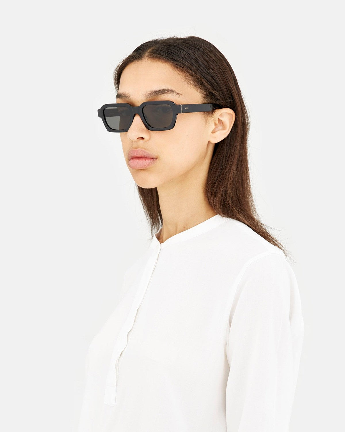 Side profile of model wearing RETROSUPERFUTURE Caro Black sunglasses.