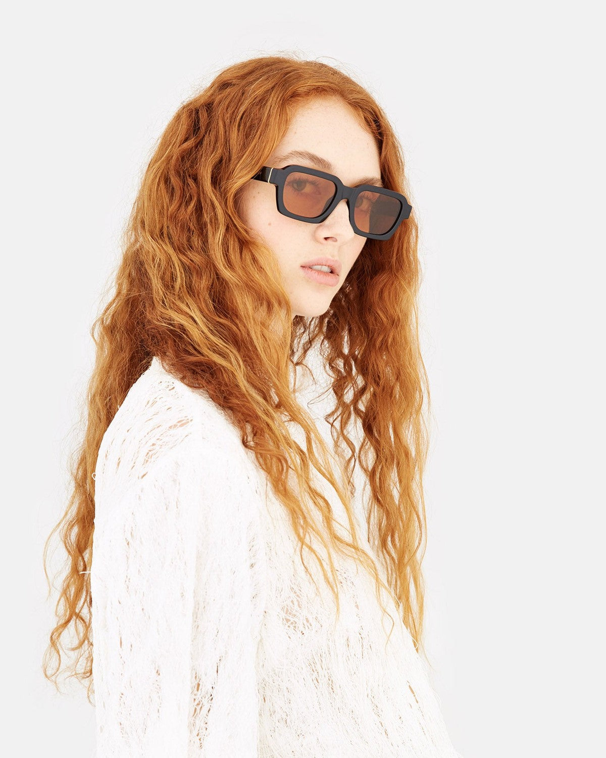 Model wearing RETROSUPERFUTURE Caro Refined sunglasses from the side.