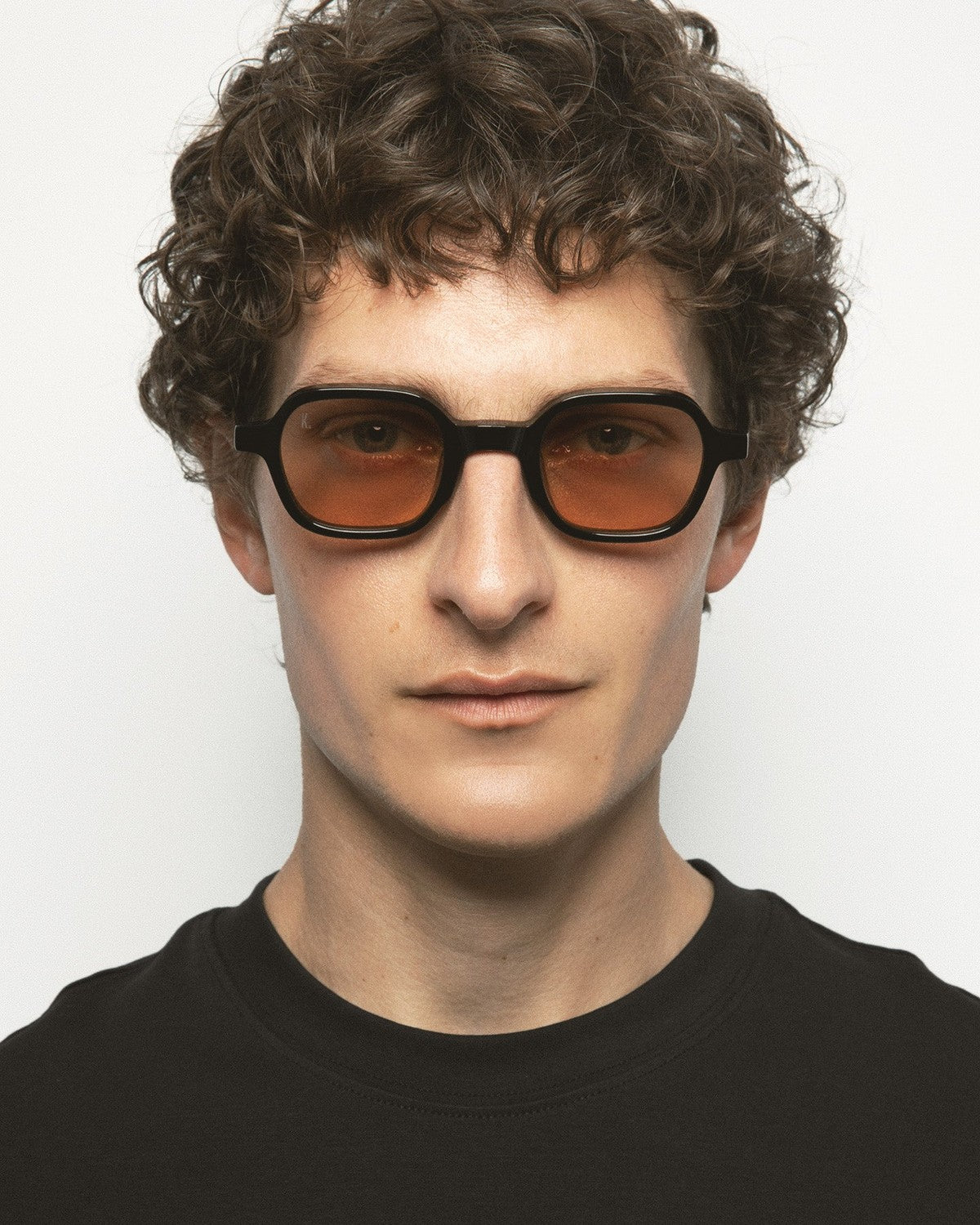 Model wearing KALEOS Castillo Black Brown sunglasses, front view.