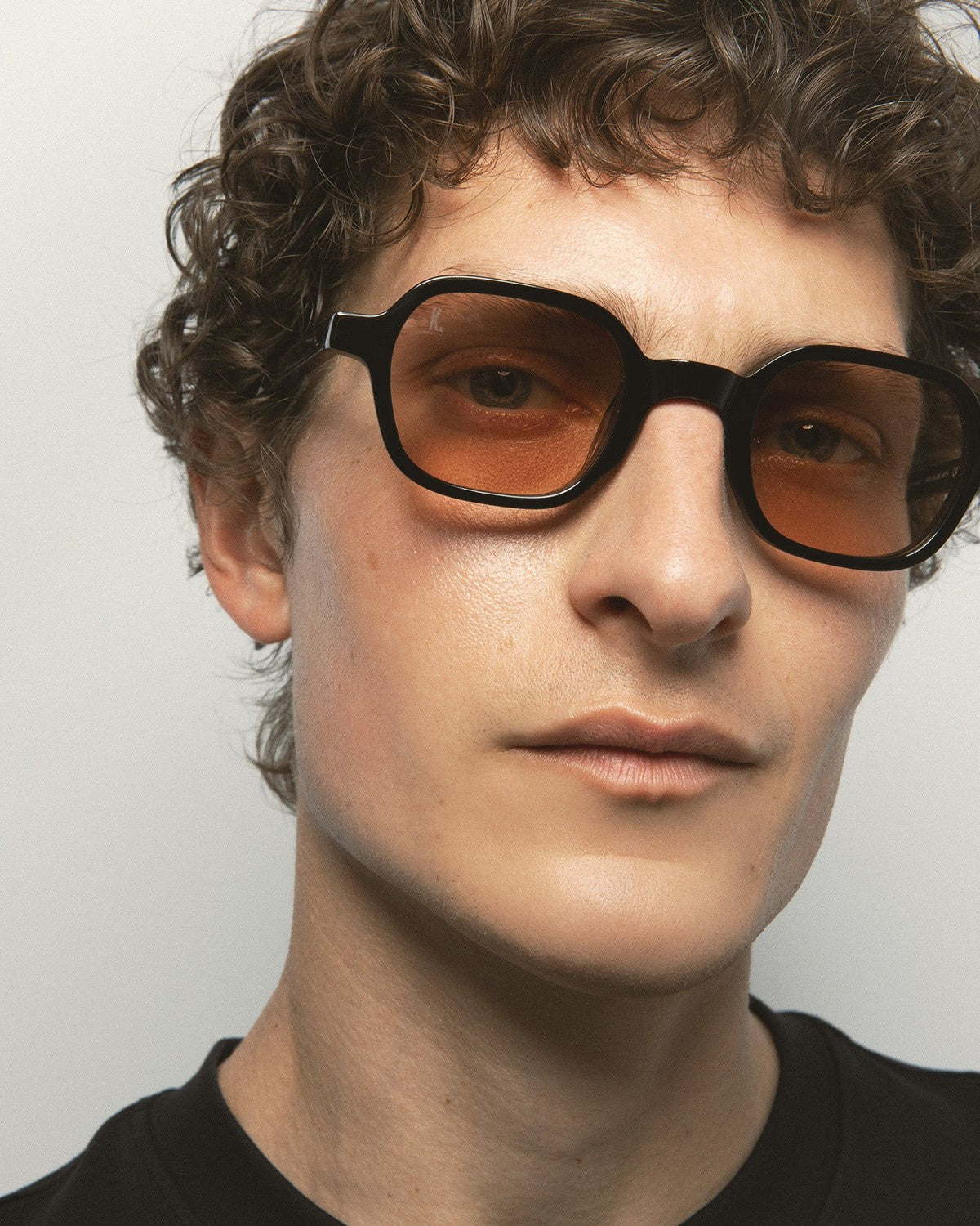 Model wearing KALEOS Castillo Black Brown sunglasses, angled view.