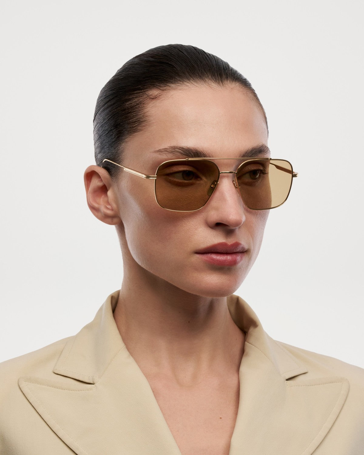 Model wearing CHIMI CC Titan Aviator Gold sunglasses from the side.