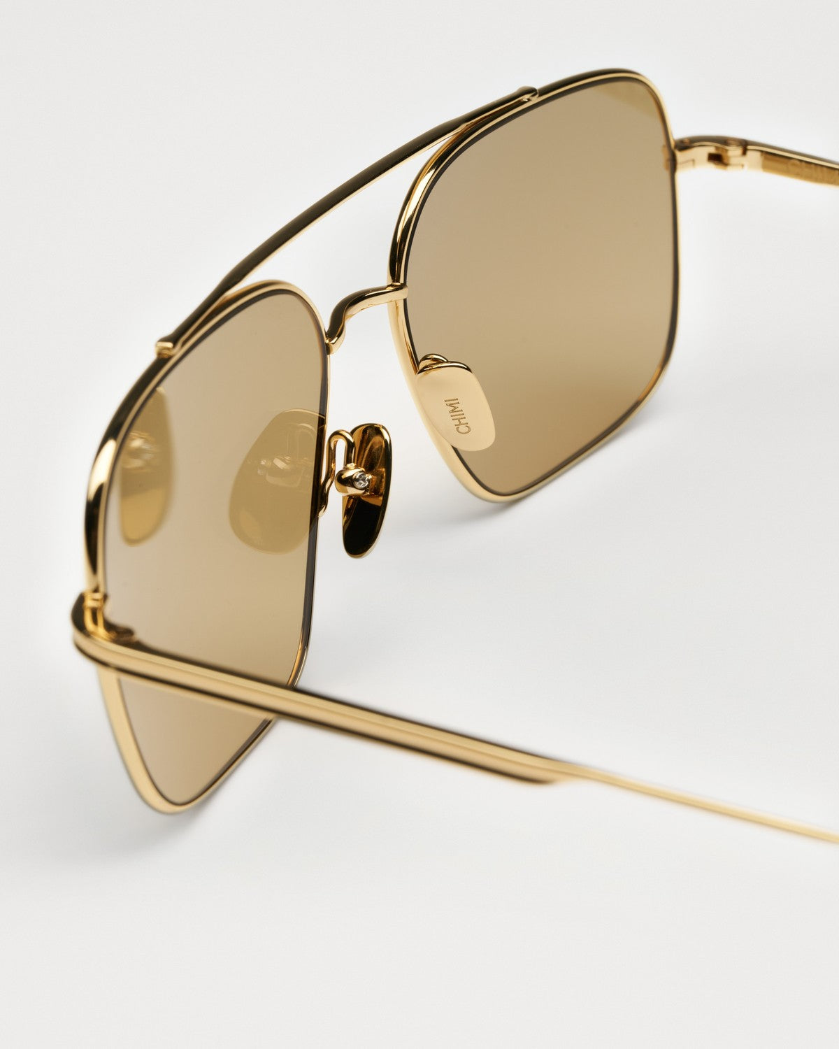 Close-up of the bridge and nose pads on CHIMI CC Titan Aviator Gold sunglasses.