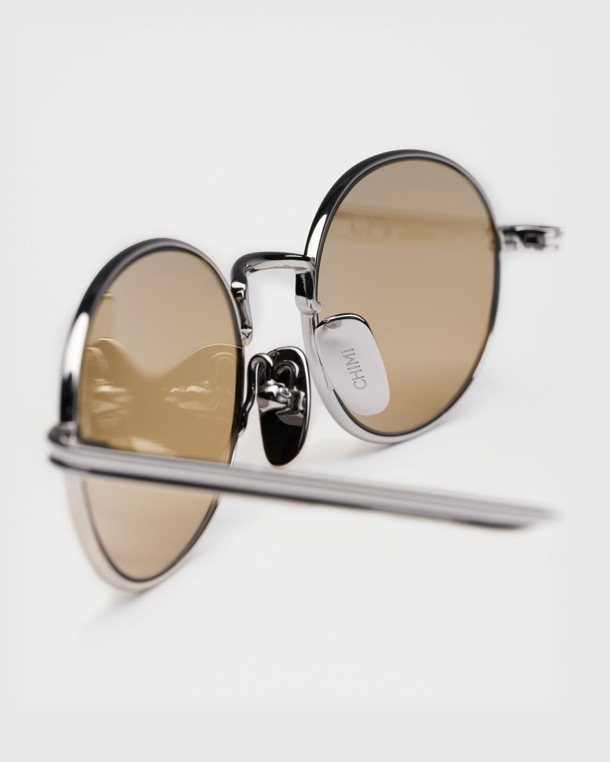 Close-up of the folded hinge on CHIMI CC Titan Oval Silver sunglasses.