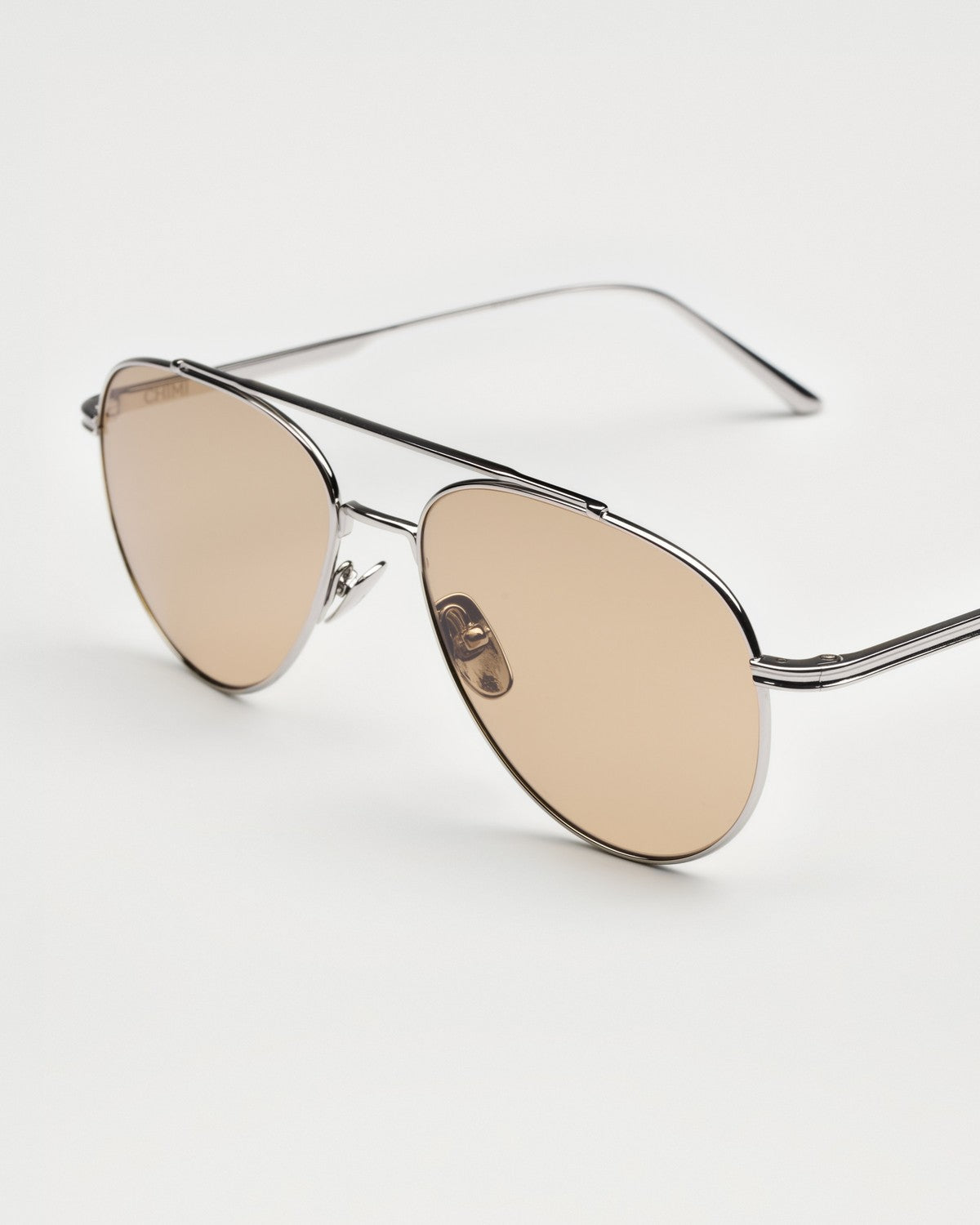 Three-quarter view of CHIMI CC Titan Pilot Silver sunglasses showing the double bridge and temples.
