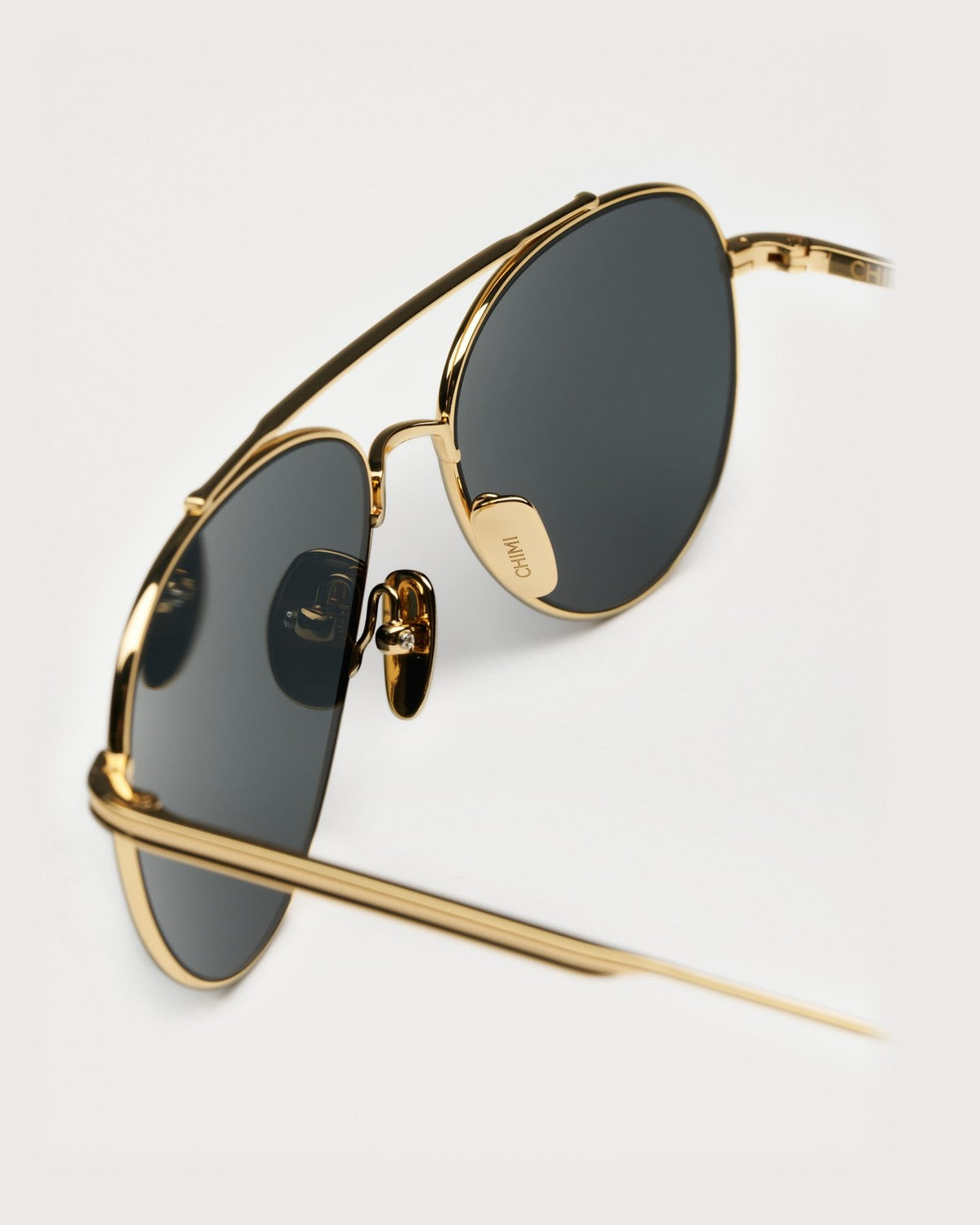 Close-up of the nose bridge and temple detail on CHIMI CC Titan Pilot Gold Brown sunglasses.